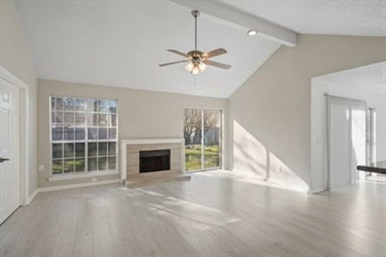 4522 Alamo Avenue, Sugar Land, TX 77479 Spacious living area with vaulted ceiling, fireplace, and abundant natural light.