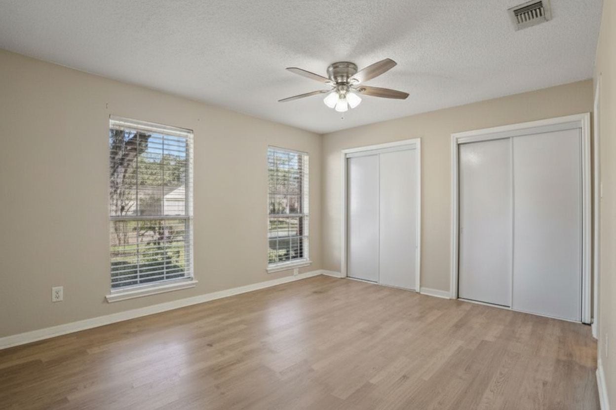 4522 Alamo Avenue, Sugar Land, TX 77479 Spacious bedroom with ceiling fan, abundant natural light, and dual closets.