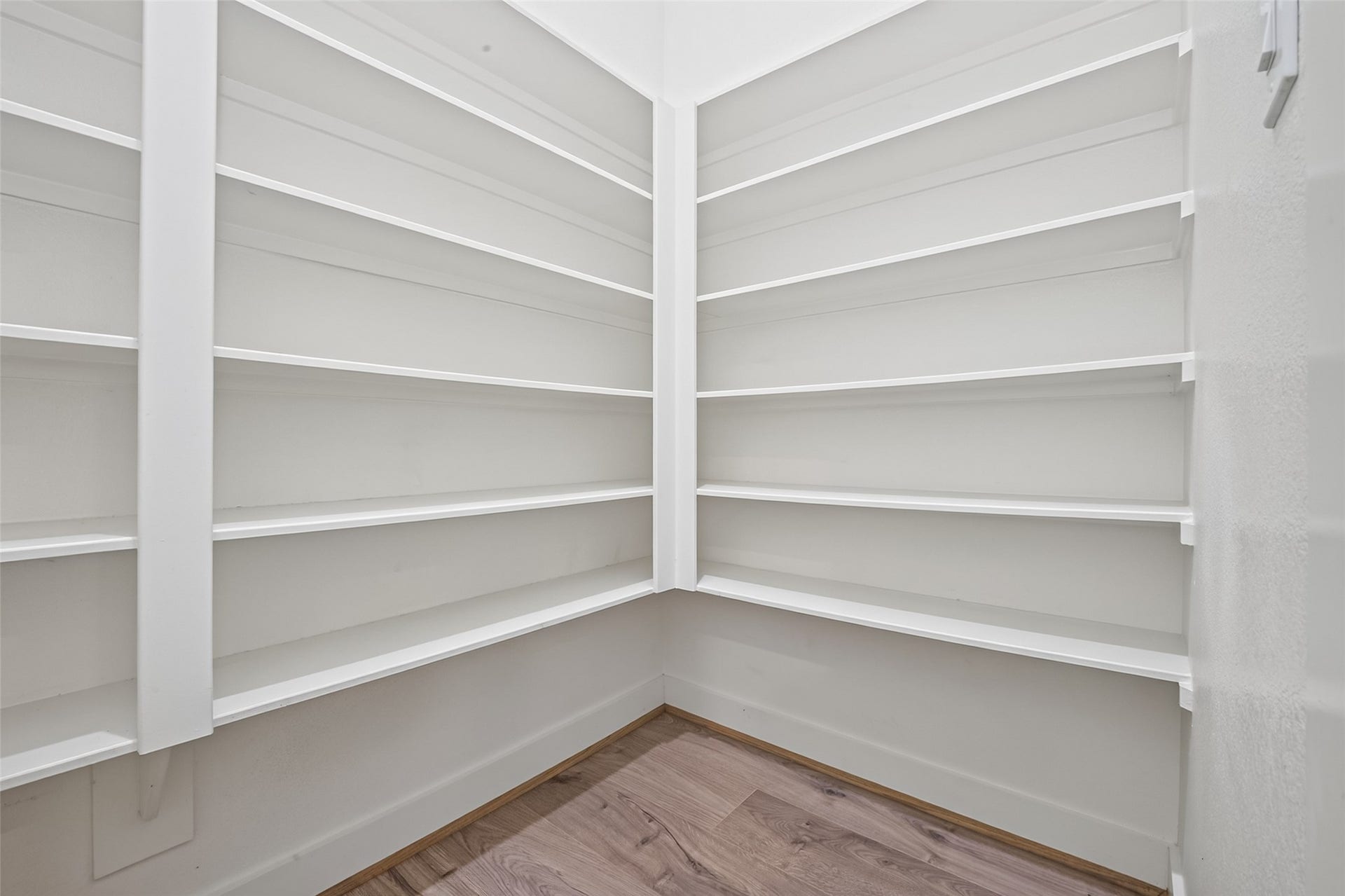 Spacious walk-in pantry featuring ample shelving for organized storage, perfect for keeping your kitchen essentials neatly arranged.