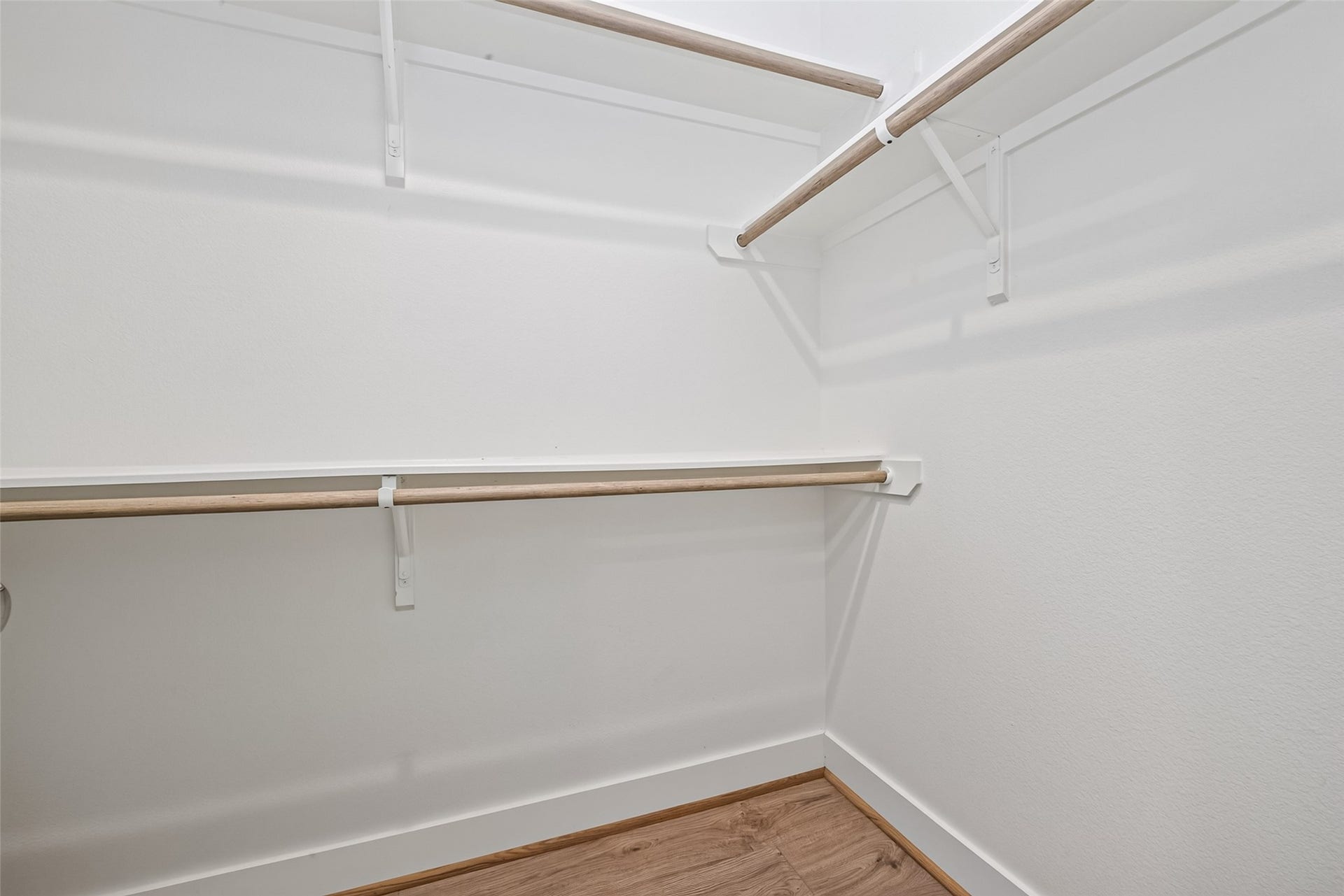 Spacious walk-in closet with ample shelving and hanging space, perfect for organizing your wardrobe.
