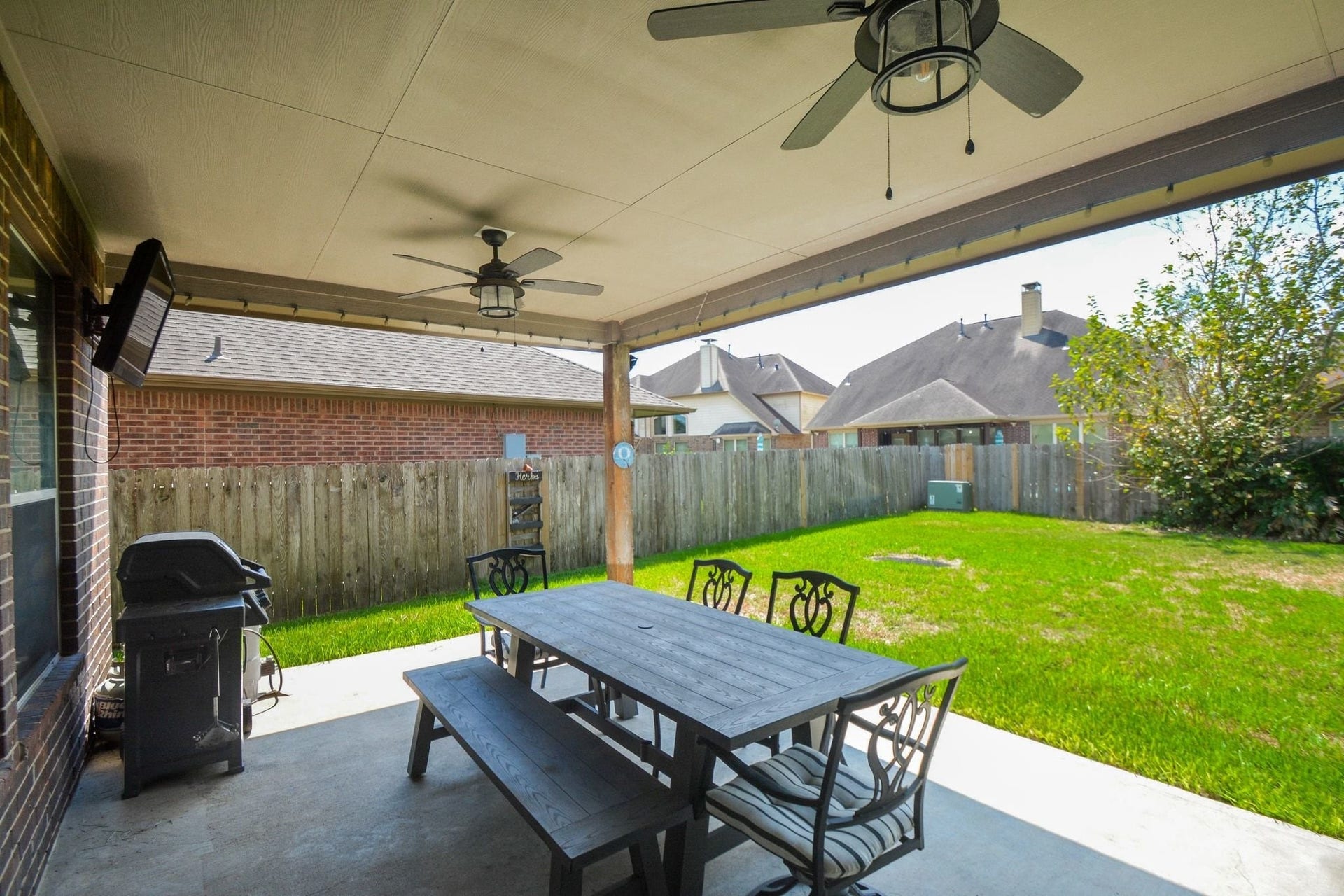 Large covered patio with ceiling fans.