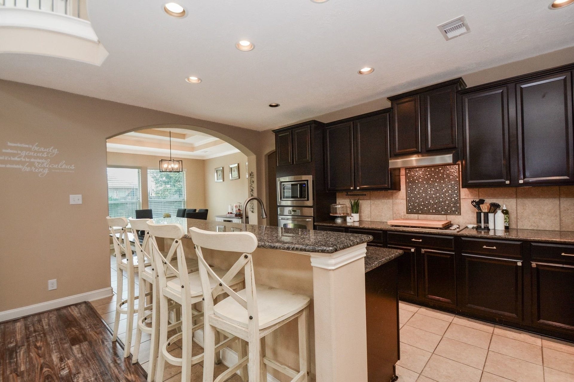 High low kitchen island with granite counters.