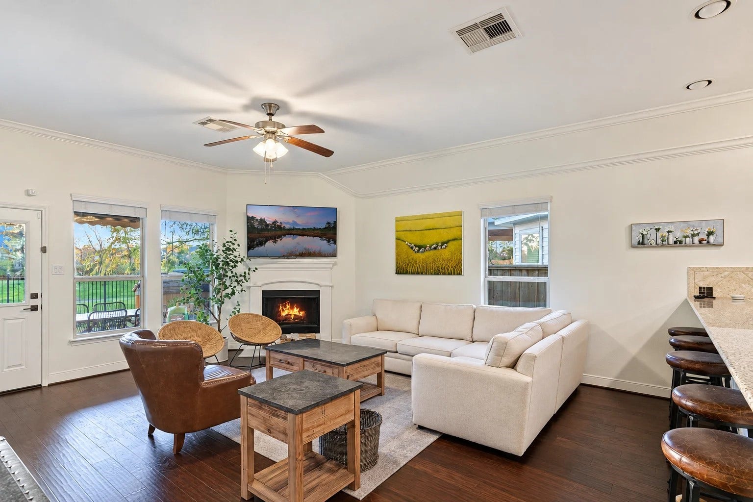 103 W Wading Pond Circle, Tomball, TX 77375 The heart of the home opens up with high ceilings, large picture windows, and a cozy corner fireplace.