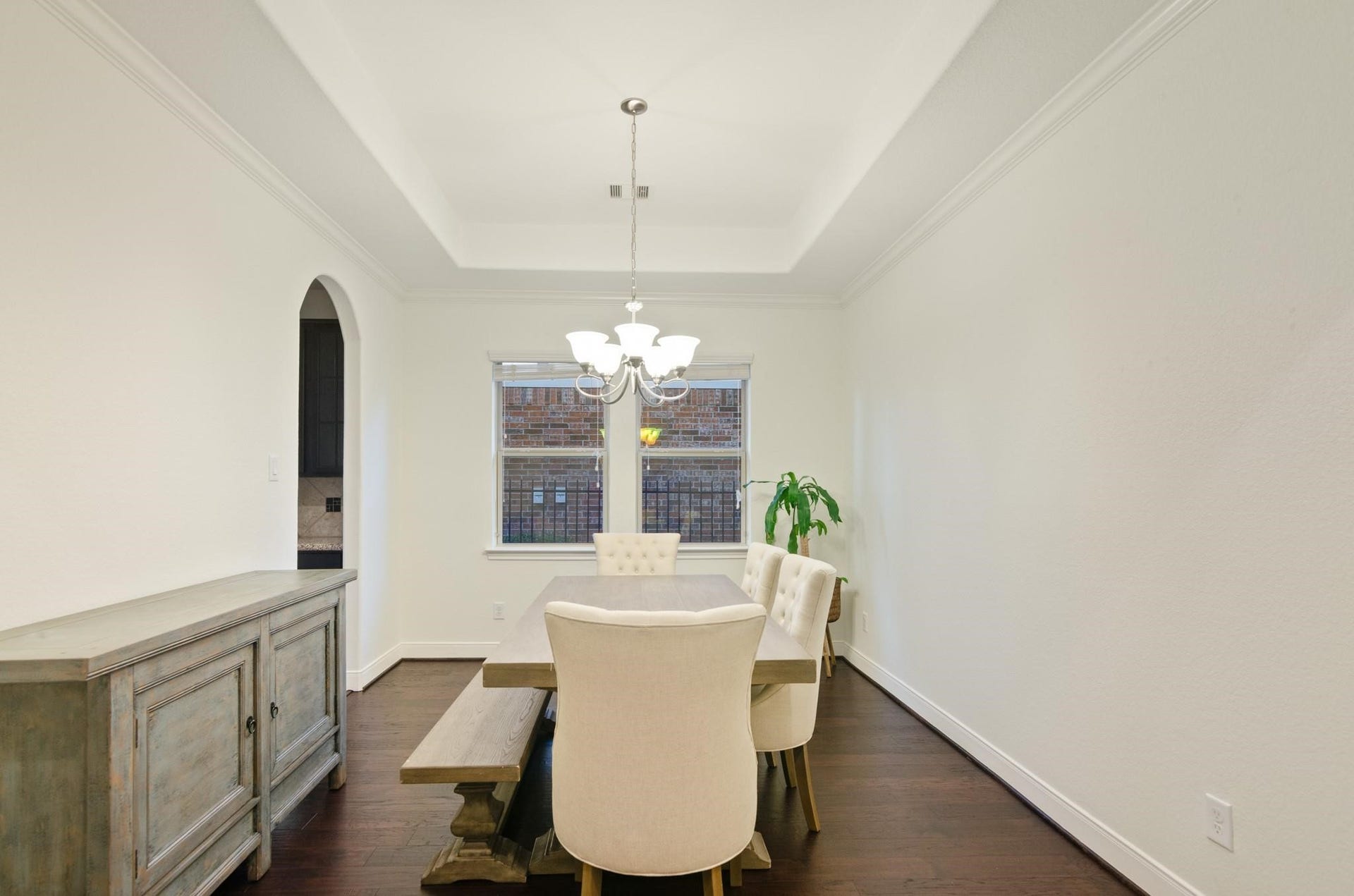 103 W Wading Pond Circle, Tomball, TX 77375 To the side of the entry, the formal dining room features tray ceilings, crown molding, and a chandelier focal point. Large windows fill the room with natural light, offering plenty of space for family dinners and festive gatherings.
