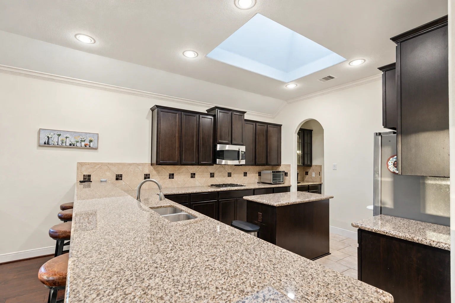 103 W Wading Pond Circle, Tomball, TX 77375 Step into the culinary heart of the home, designed with both daily meals and effortless entertaining in mind.