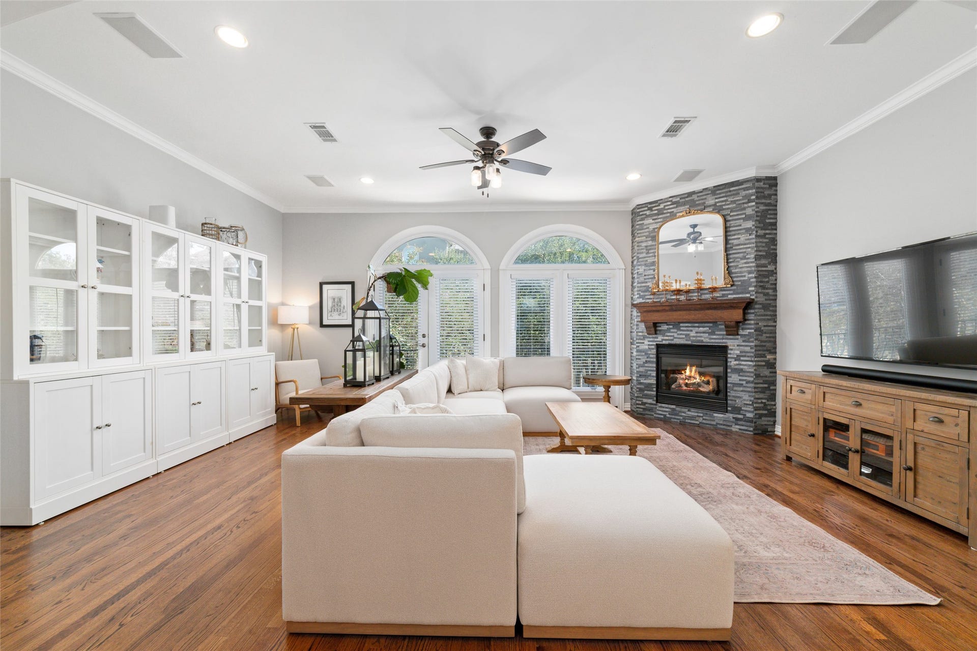 Spacious living room featuring a cozy fireplace and private balcony