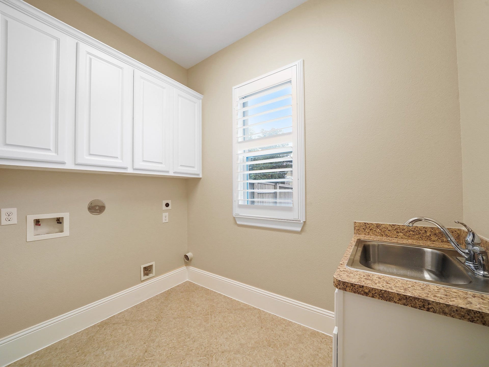 27710 Guthrie Ridge Lane, Katy, TX 77494 Beyond the main living spaces, the utility room pairs practical cabinetry and generous workspace for polished everyday function.