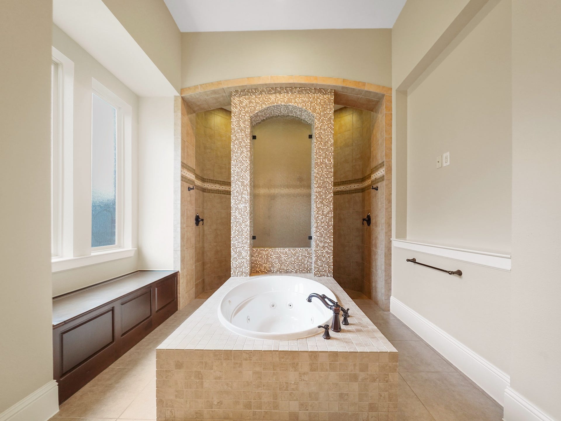 27710 Guthrie Ridge Lane, Katy, TX 77494 At its center, the jetted soaking tub invites a quiet end-of-day ritual within the spacious, light-filled ensuite. While the walk-through shower raises the bar with multiple showerheads and striking tilework, making an everyday routine feel a little more indulgent.