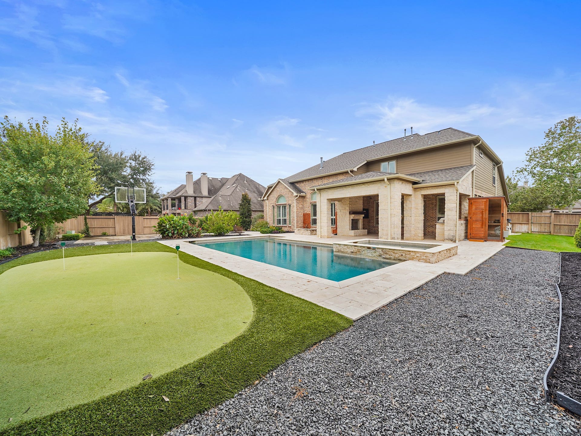27710 Guthrie Ridge Lane, Katy, TX 77494 Just beyond the back door, a sprawling outdoor retreat beckons with spaces to swim, gather, dine, and play under the Texas sky.