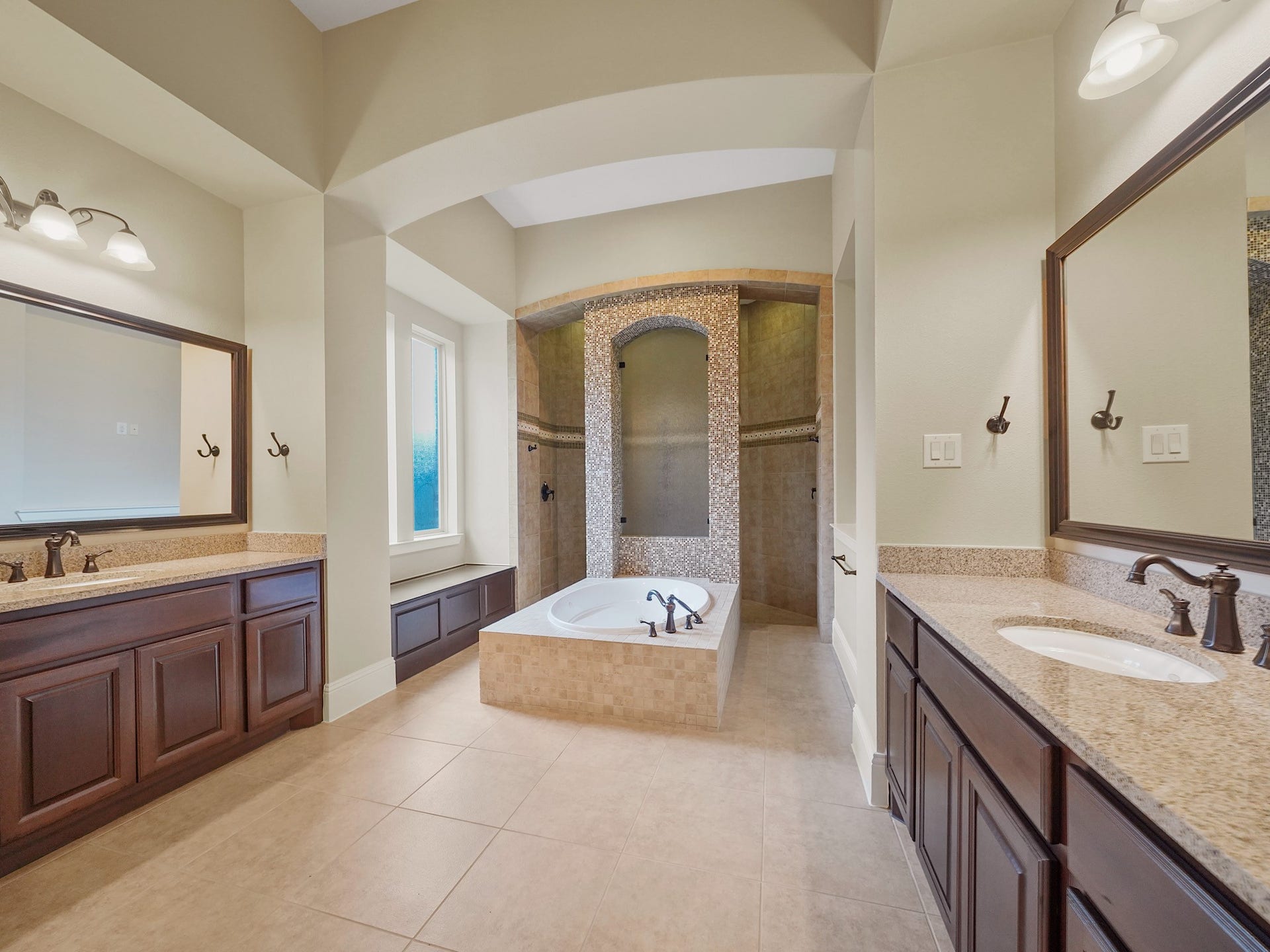 27710 Guthrie Ridge Lane, Katy, TX 77494 The primary ensuite feels like a private spa, with a jetted soaking tub, dual vanities, and an expansive walk-through shower outfitted with multiple showerheads.
