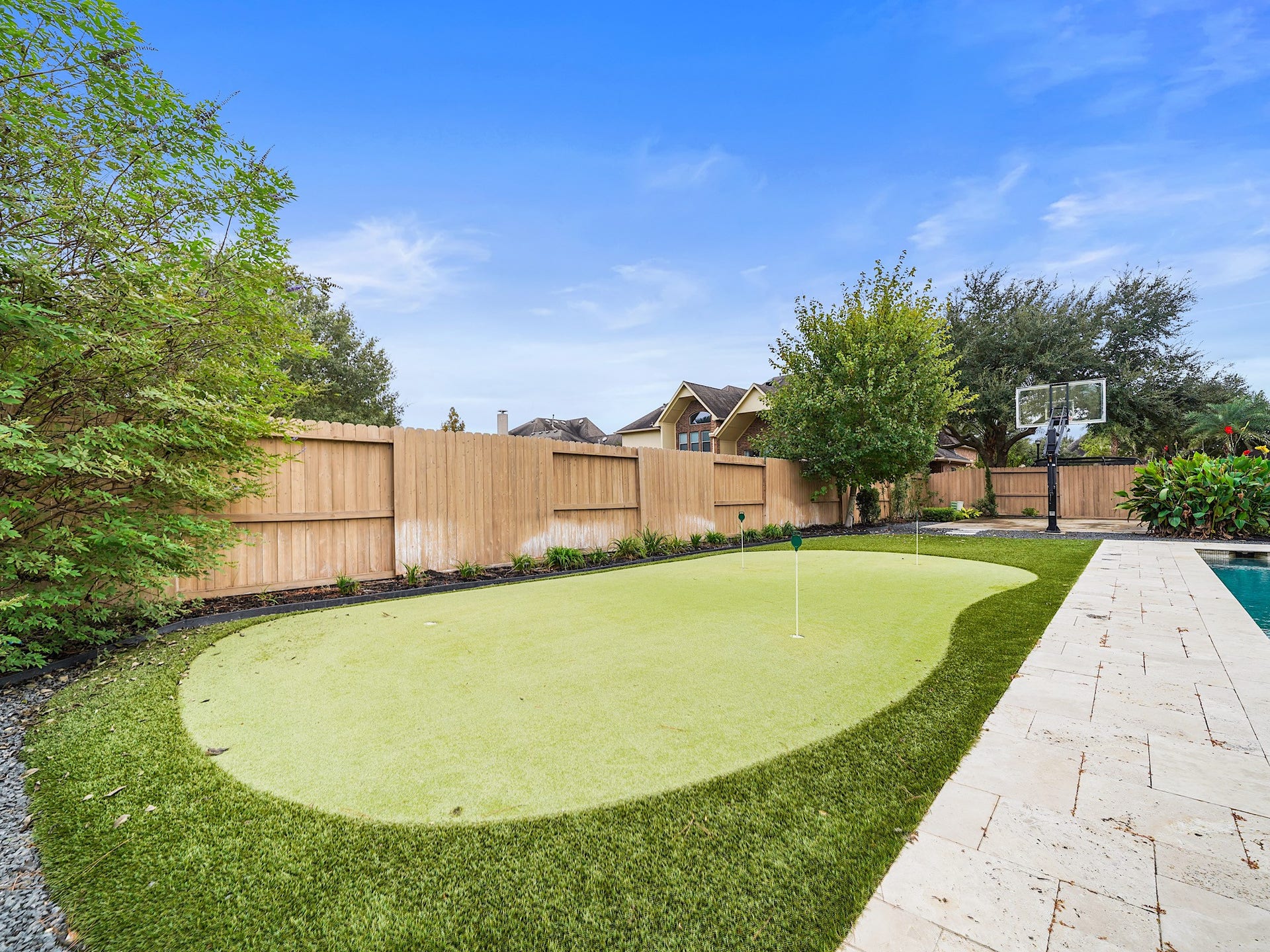 27710 Guthrie Ridge Lane, Katy, TX 77494 For a little friendly competition, the putting green brings a playful touch to the expansive lawn.