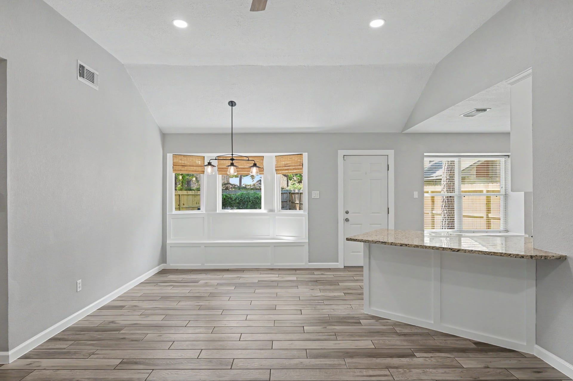The vaulted ceiling and windows overlooking the backyard make the space feel large and very bright with all the natural light.