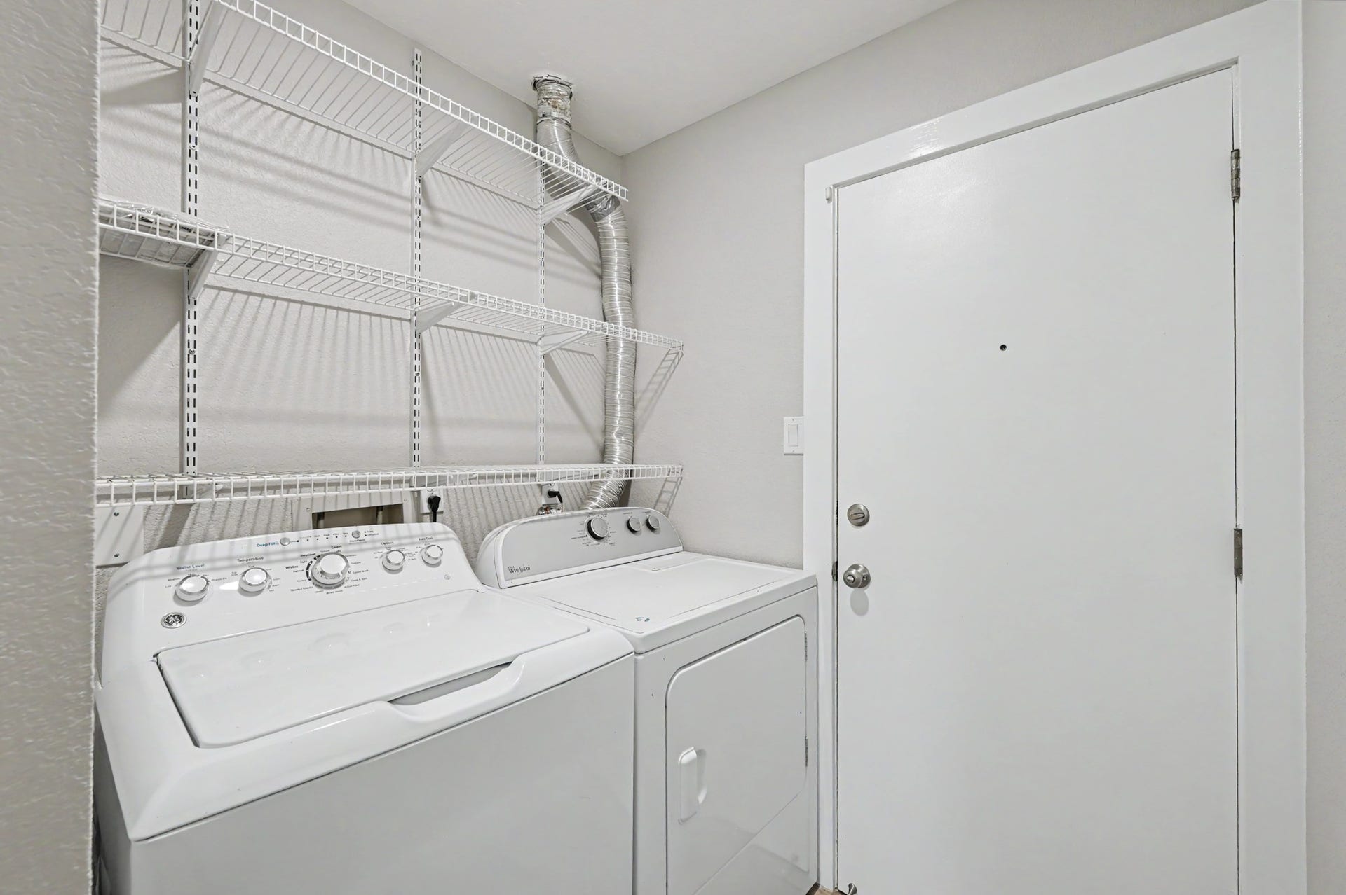 The Utility room is located in the home with extra storage located above the Washer & Dryer which are provided along with a coat closet.  The utility room leads you to the 2-car garage.
