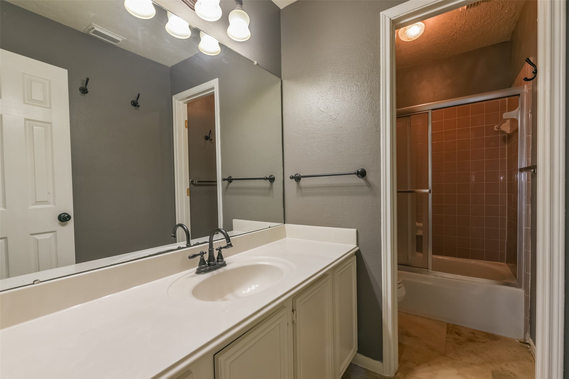 2509 S Mission Circle, Friendswood, TX 77546 Experience the sleek charm of this secondary bath, featuring a spacious vanity, elegant fixtures, and a tiled shower perfect for relaxation.