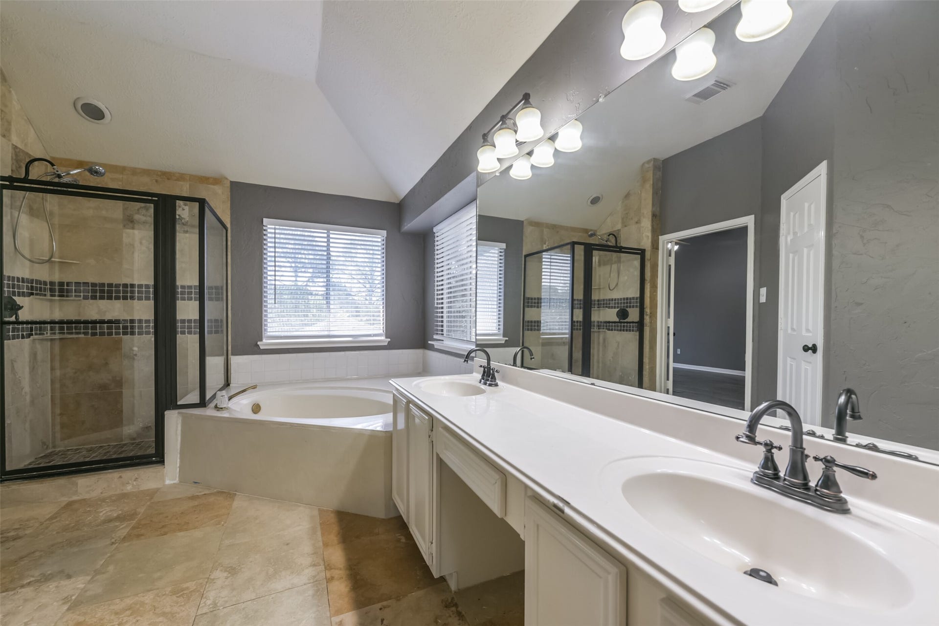 2509 S Mission Circle, Friendswood, TX 77546 Indulge in luxury with a spacious bathroom featuring a separate jetted tub and a sleek walk-in shower, perfect for relaxation.