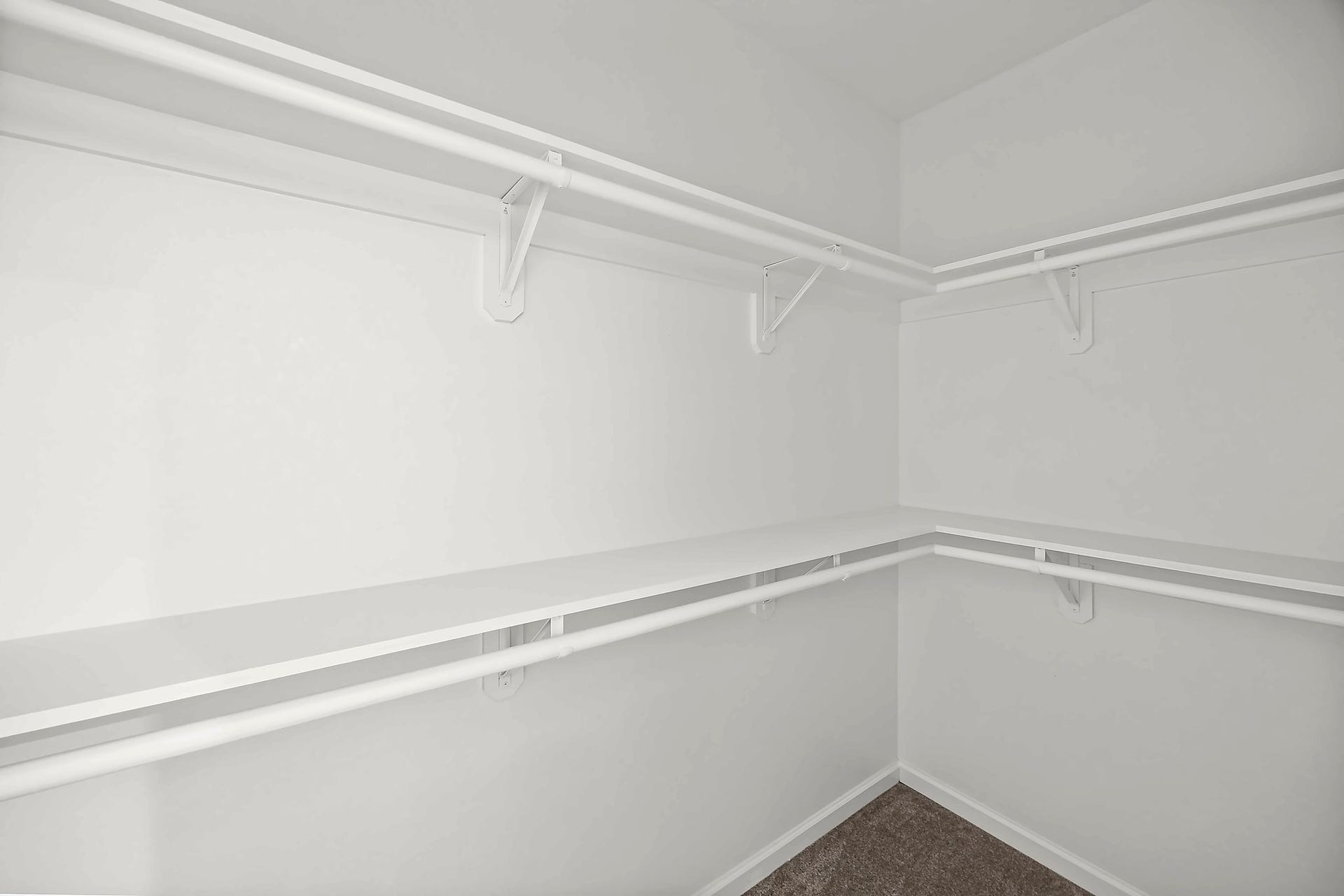 10426 Royal Oaks Drive, Houston, TX 77016 Spacious walk-in closet featuring double hanging rods and ample shelving for organized storage.