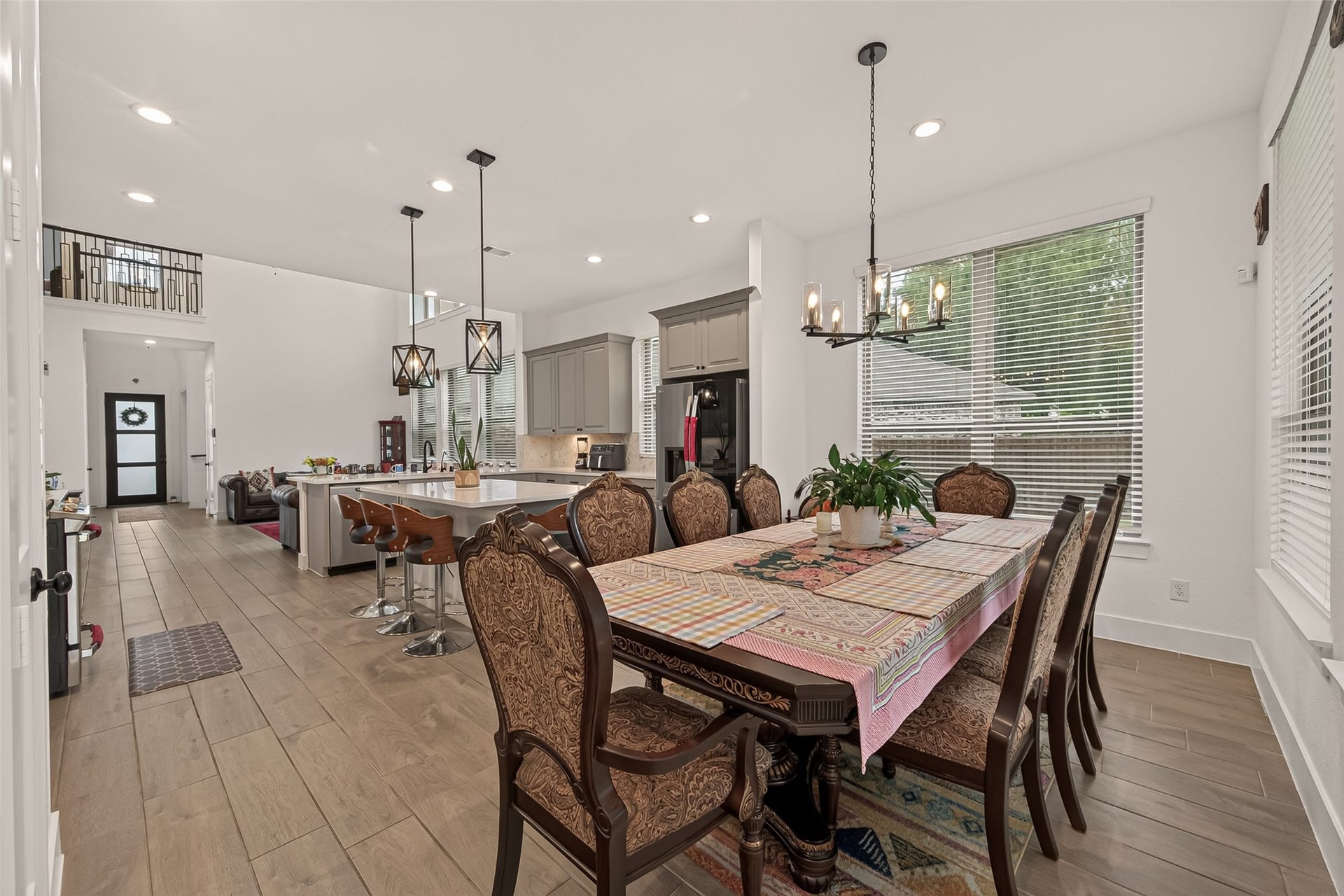 10730 Hidden Rock Drive, Missouri City, TX 77459 Spacious dining area featuring a beautiful chandelier and recessed lighting, perfectly designed to accommodate a table for eight.