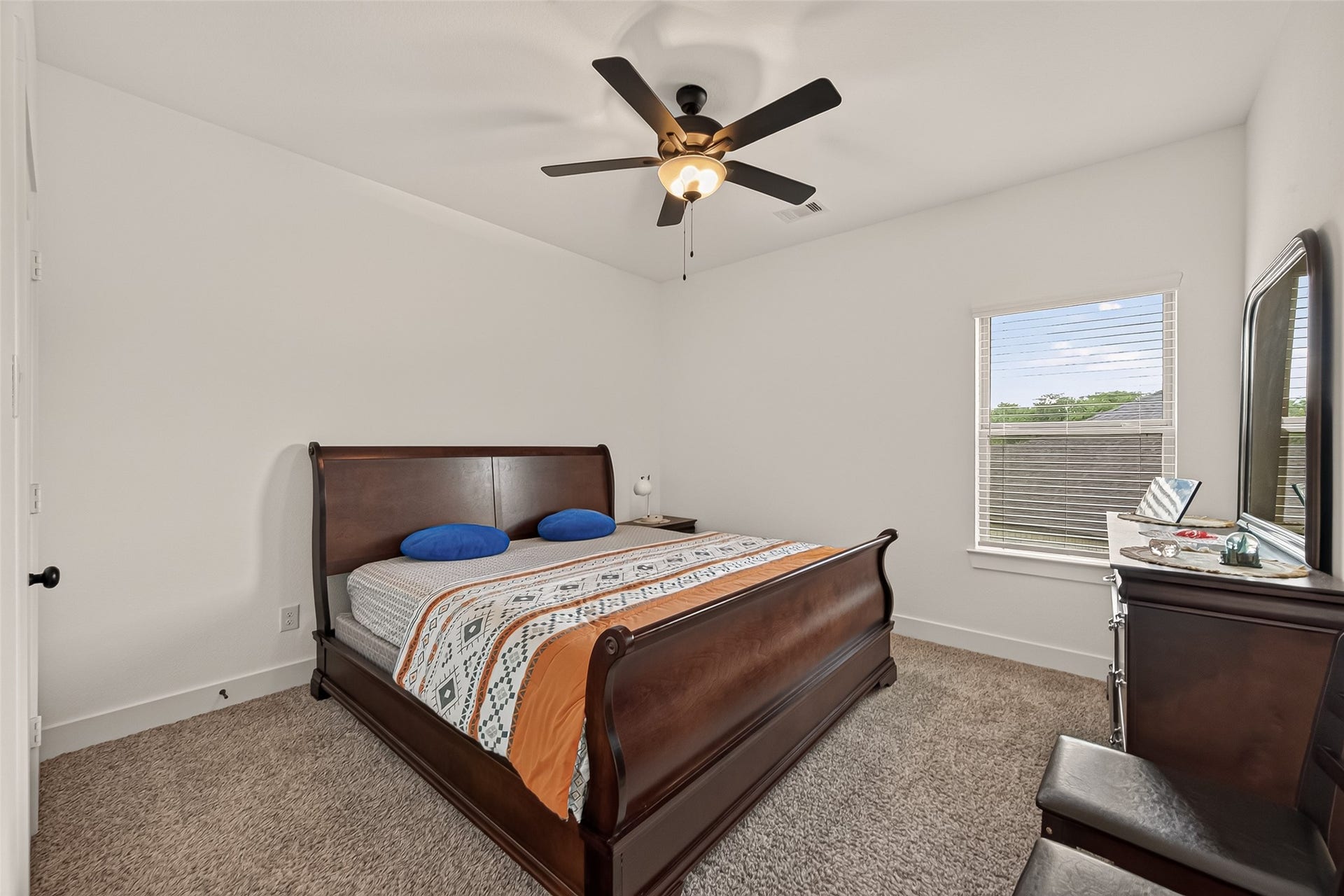 10730 Hidden Rock Drive, Missouri City, TX 77459 This view highlights the pristine condition of the carpeting and the expansive windows, which provide ample natural light.