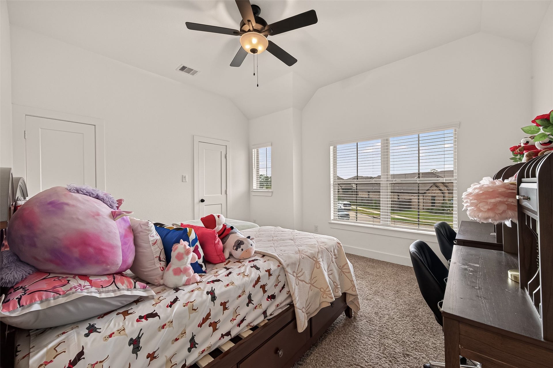 10730 Hidden Rock Drive, Missouri City, TX 77459 Spacious secondary bedroom located on the second floor, positioned directly to the right of the upstairs game/family room. This room features oversized windows offering a bright street-facing view, a large walk-in closet, and a ceiling fan for climate control. Additionally, it provides the convenience of direct private access to the secondary bathroom.