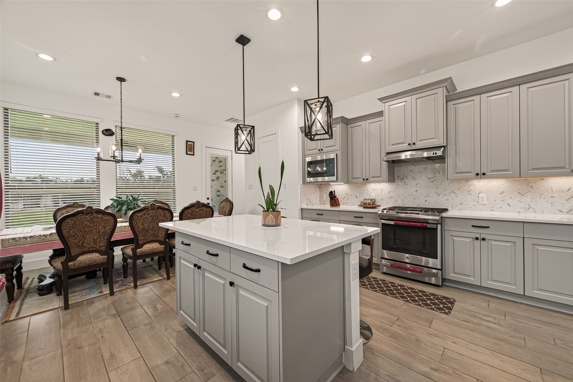 10730 Hidden Rock Drive, Missouri City, TX 77459 Dining area with seamless access to the kitchen, featuring an expansive wall of windows that frame a picturesque view of the spacious backyarda perfect canvas for your custom outdoor oasis.