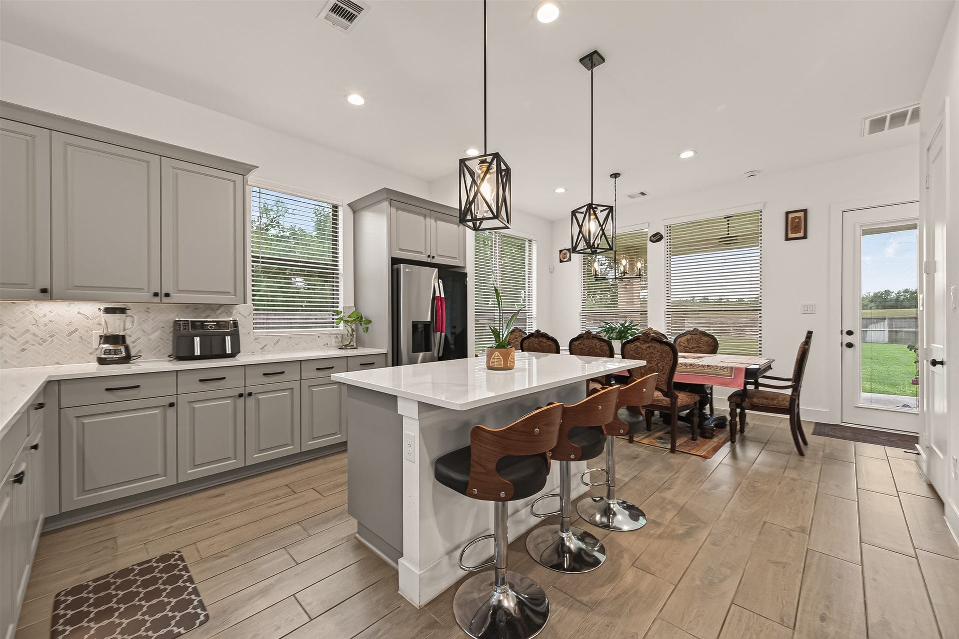 10730 Hidden Rock Drive, Missouri City, TX 77459 Open floor plan kitchen featuring ample space and a large island, perfect for multi-chef meal preparation.