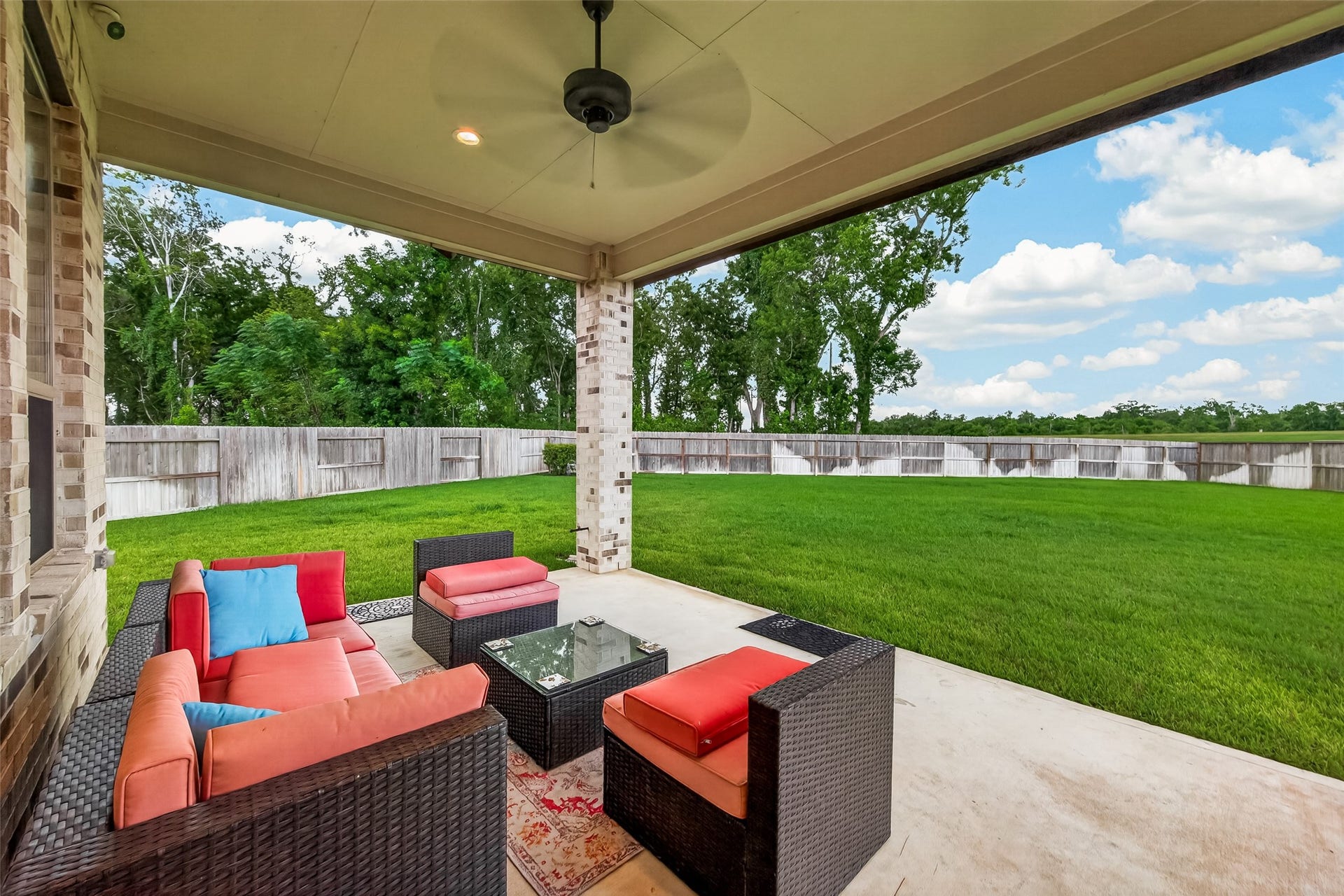10730 Hidden Rock Drive, Missouri City, TX 77459 Covered patio overlooking the spacious backyard, featuring ample space for an outdoor kitchen and a pre-installed gas line connection ready for immediate use.