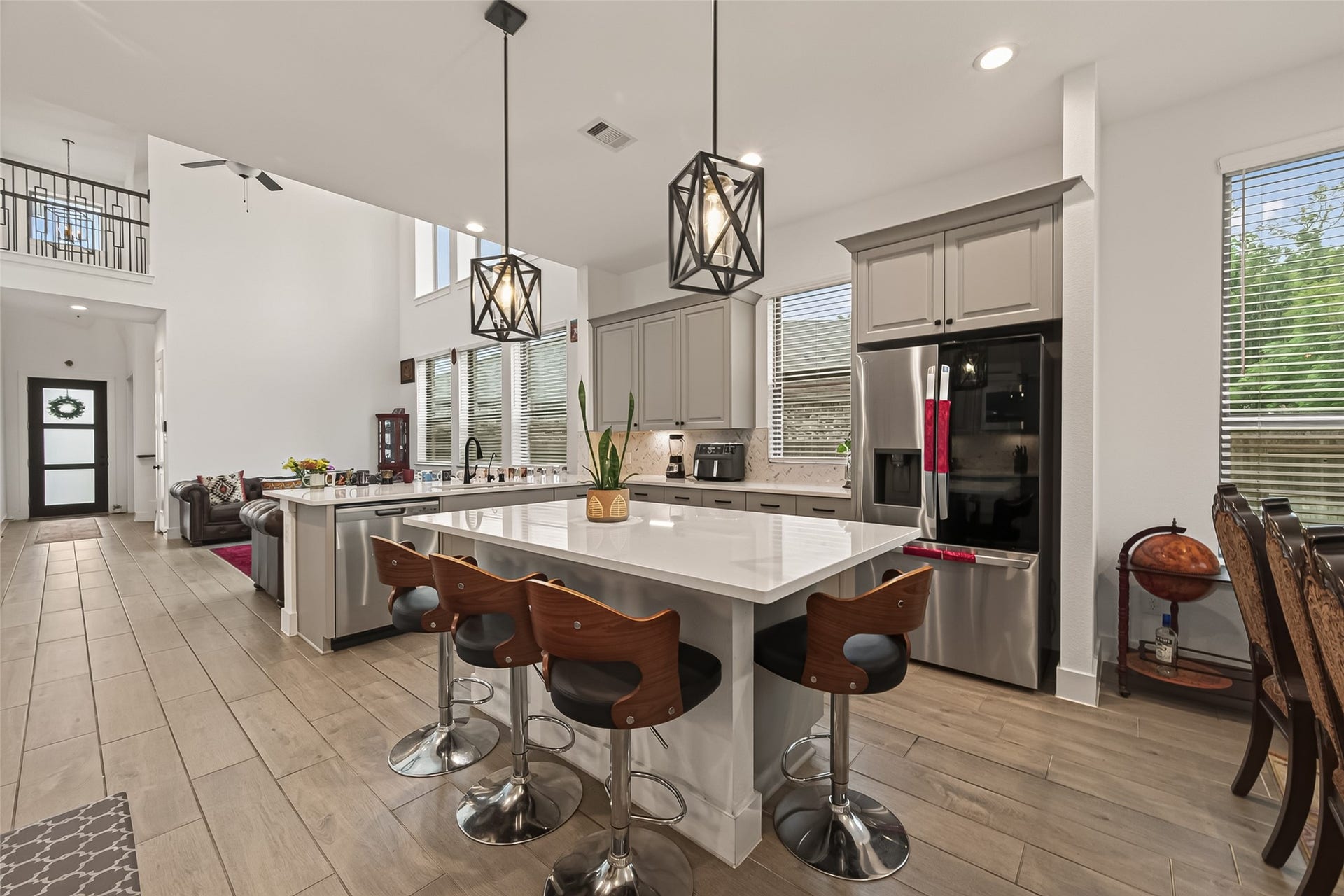 10730 Hidden Rock Drive, Missouri City, TX 77459 This breakfast bar features a stunning quartz countertop and comfortably accommodates seating for three bar stools.