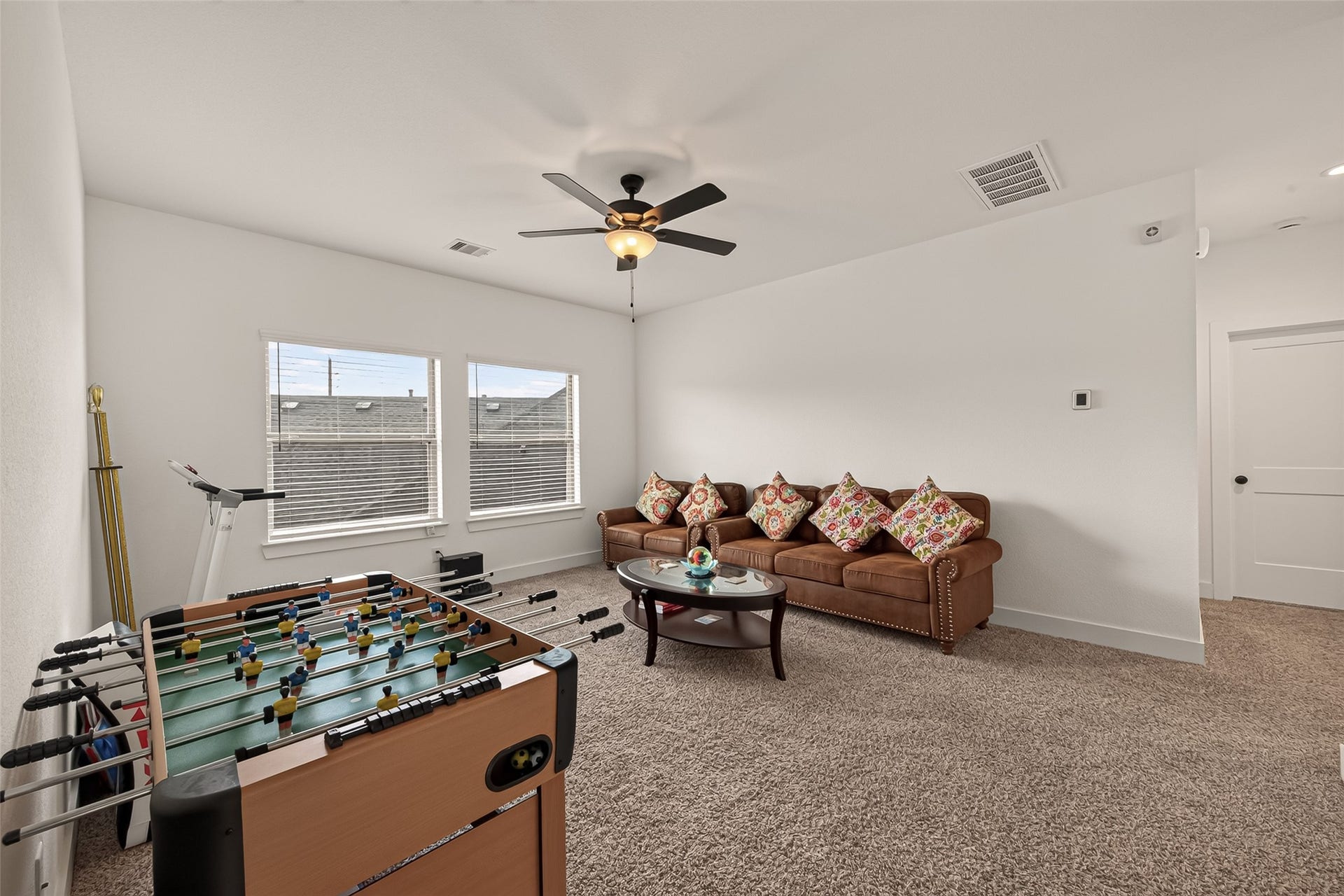 10730 Hidden Rock Drive, Missouri City, TX 77459 Upstairs you will be welcomed by the very spacious game room/second family room, featuring oversized windows that allow for plenty of natural light and a ceiling fan for added comfort. The carpeting throughout this area is in excellent, like-new condition.