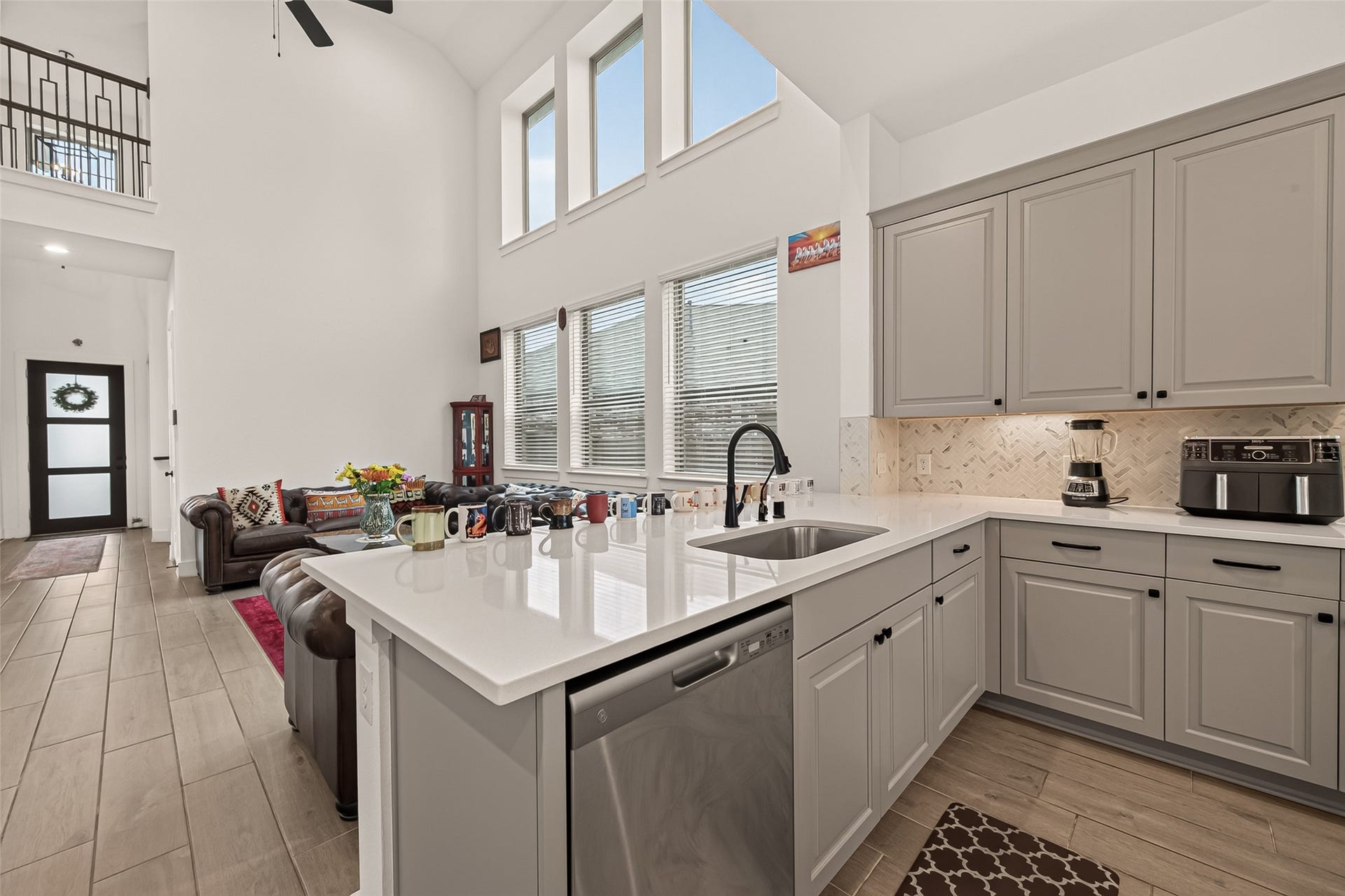 10730 Hidden Rock Drive, Missouri City, TX 77459 This kitchen is a standout feature of the home, boasting an abundance of storage space, high-end stainless steel appliances, and elegant tile flooring throughout.