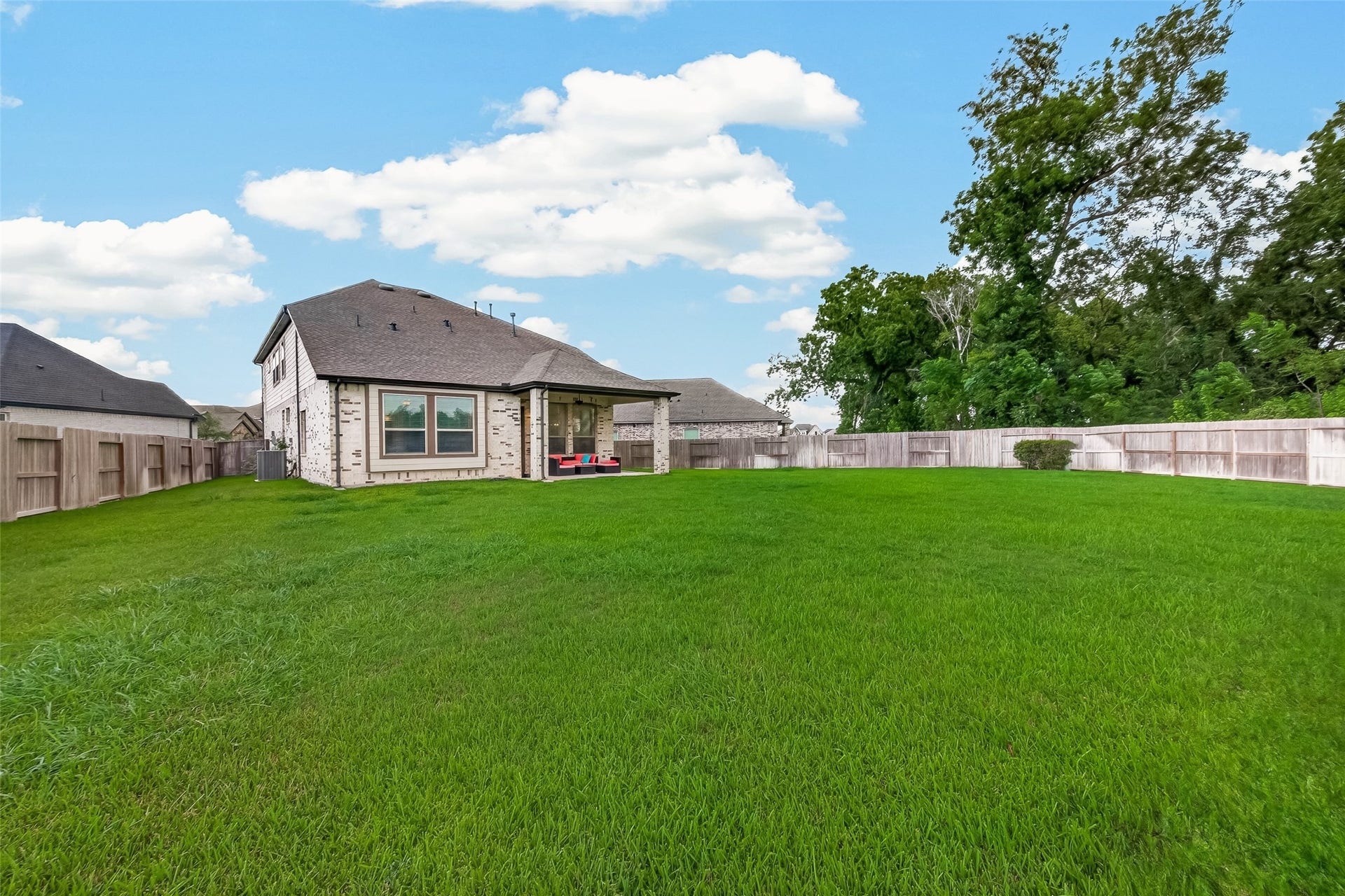 10730 Hidden Rock Drive, Missouri City, TX 77459 The expansive backyard, one of the largest in the neighborhood, offers limitless potential for customization; enjoy this generous outdoor space from the comfort of your private covered patio.