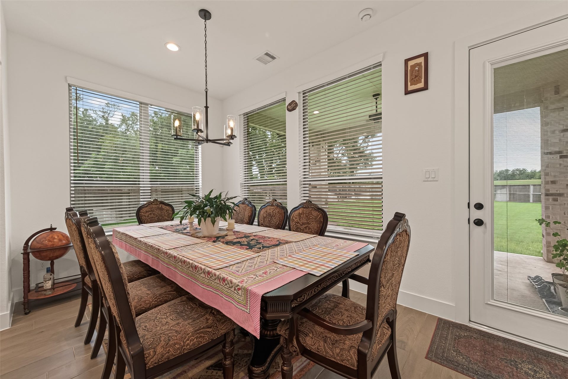 10730 Hidden Rock Drive, Missouri City, TX 77459 Dining area featuring large windows overlooking the backyard and covered patio, allowing for an abundance of natural light to flow throughout the space.