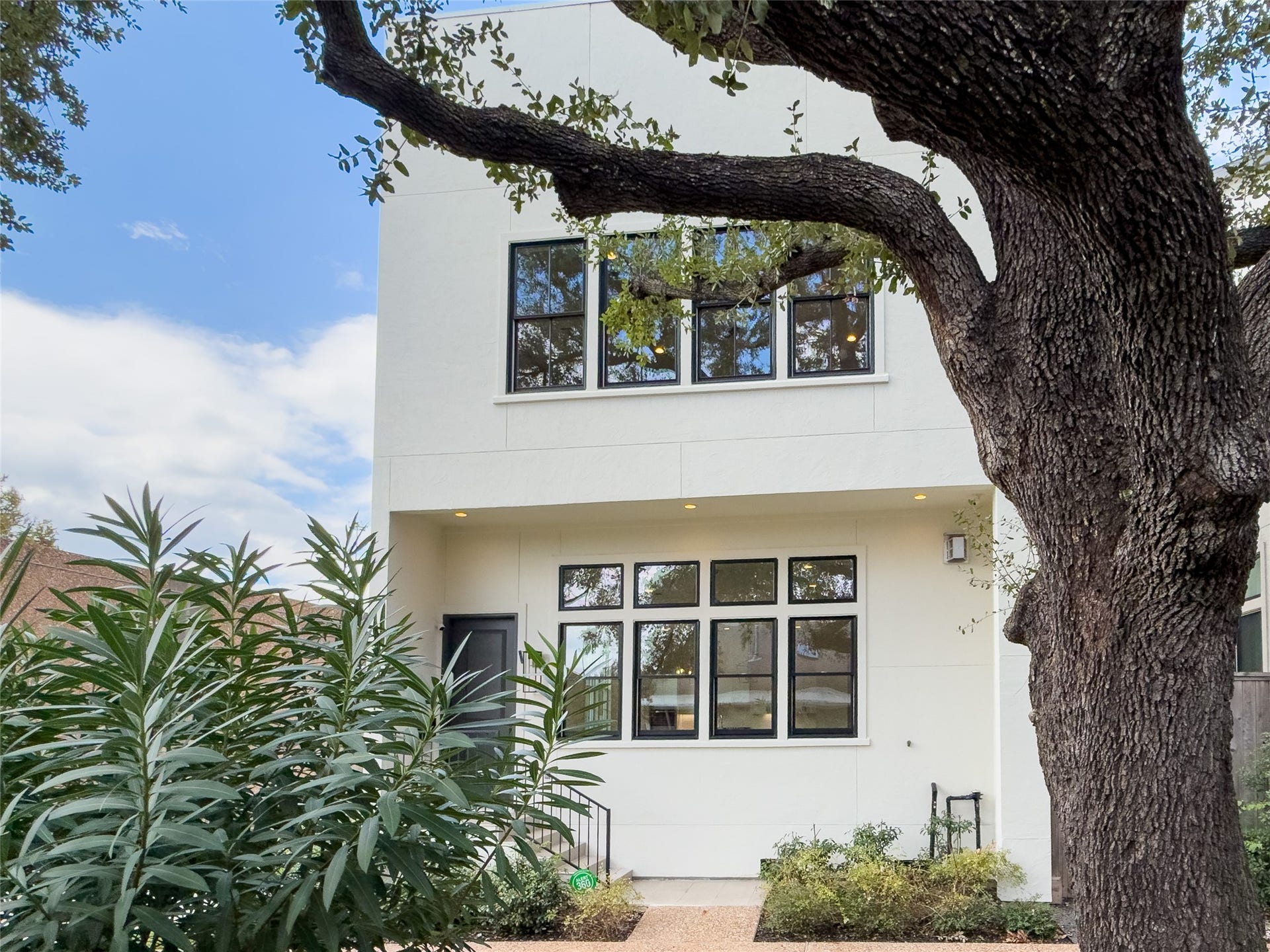 Majestic oak trees line the large common community courtyard in front of townhome. All photo captions per builder.