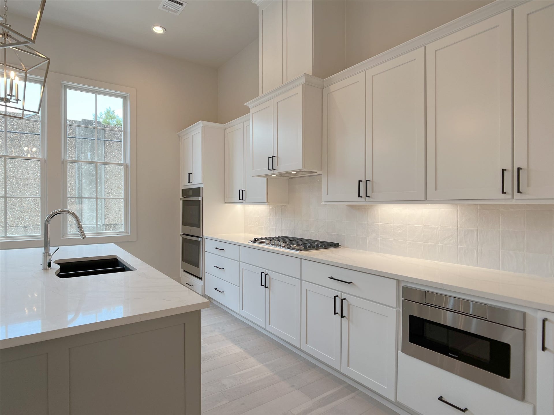 quartz countertops throughout the home, abundant lovely windows