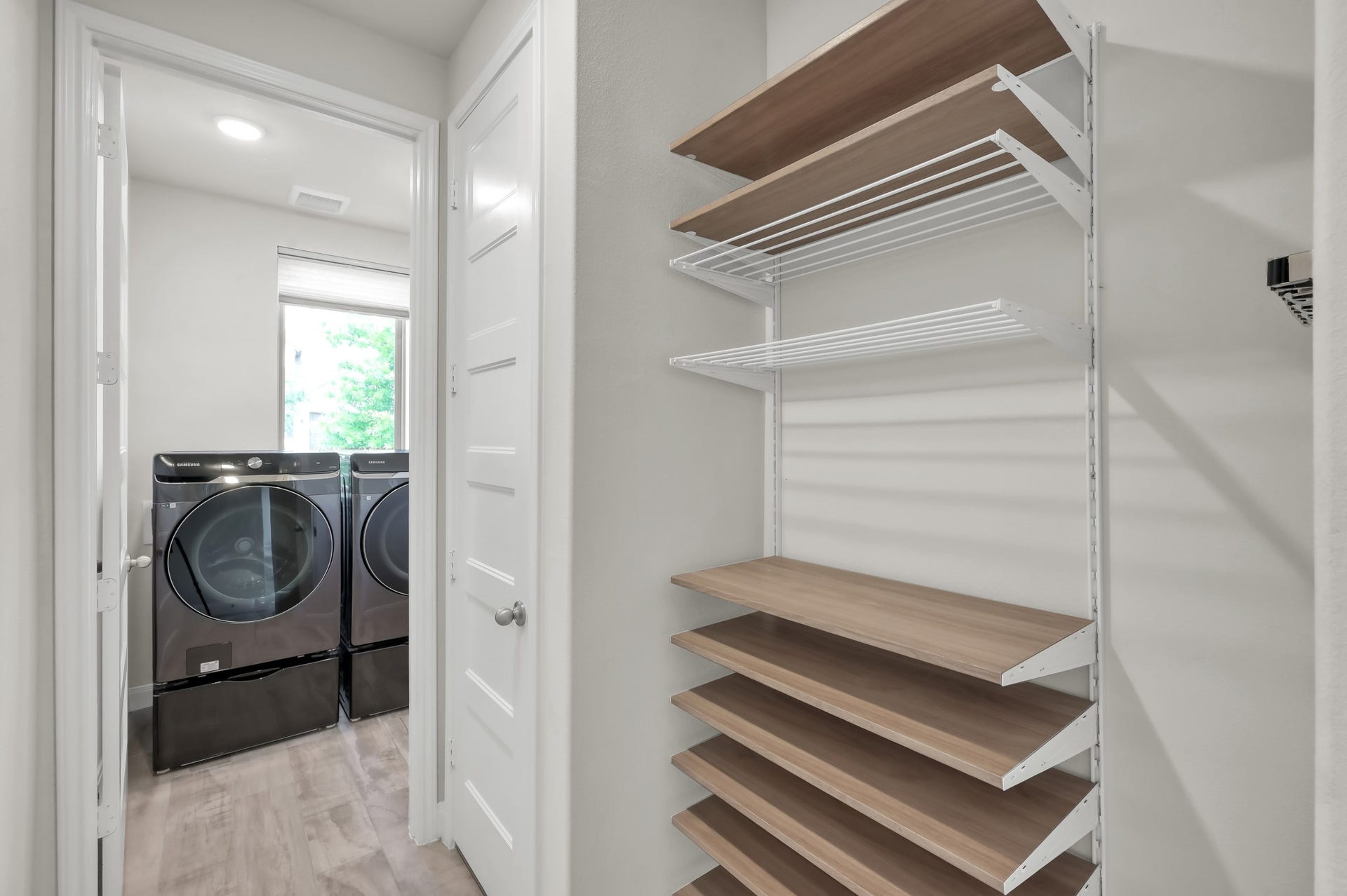 550 Chestnut Reef Court, Conroe, TX 77304 Clean, modern storage nook with adjustable shelving beside a bright laundry roomsimple and functional.