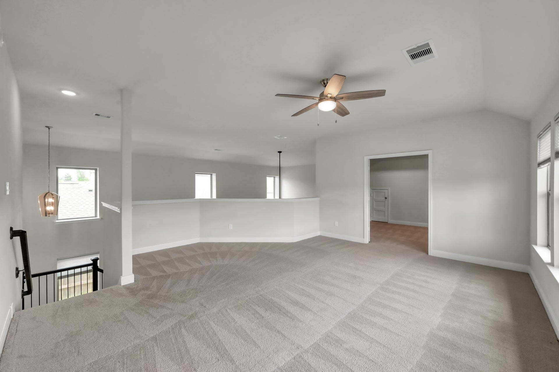 550 Chestnut Reef Court, Conroe, TX 77304 Upstairs game room with connected media room ideal for movie nights, gaming, and family entertainment.