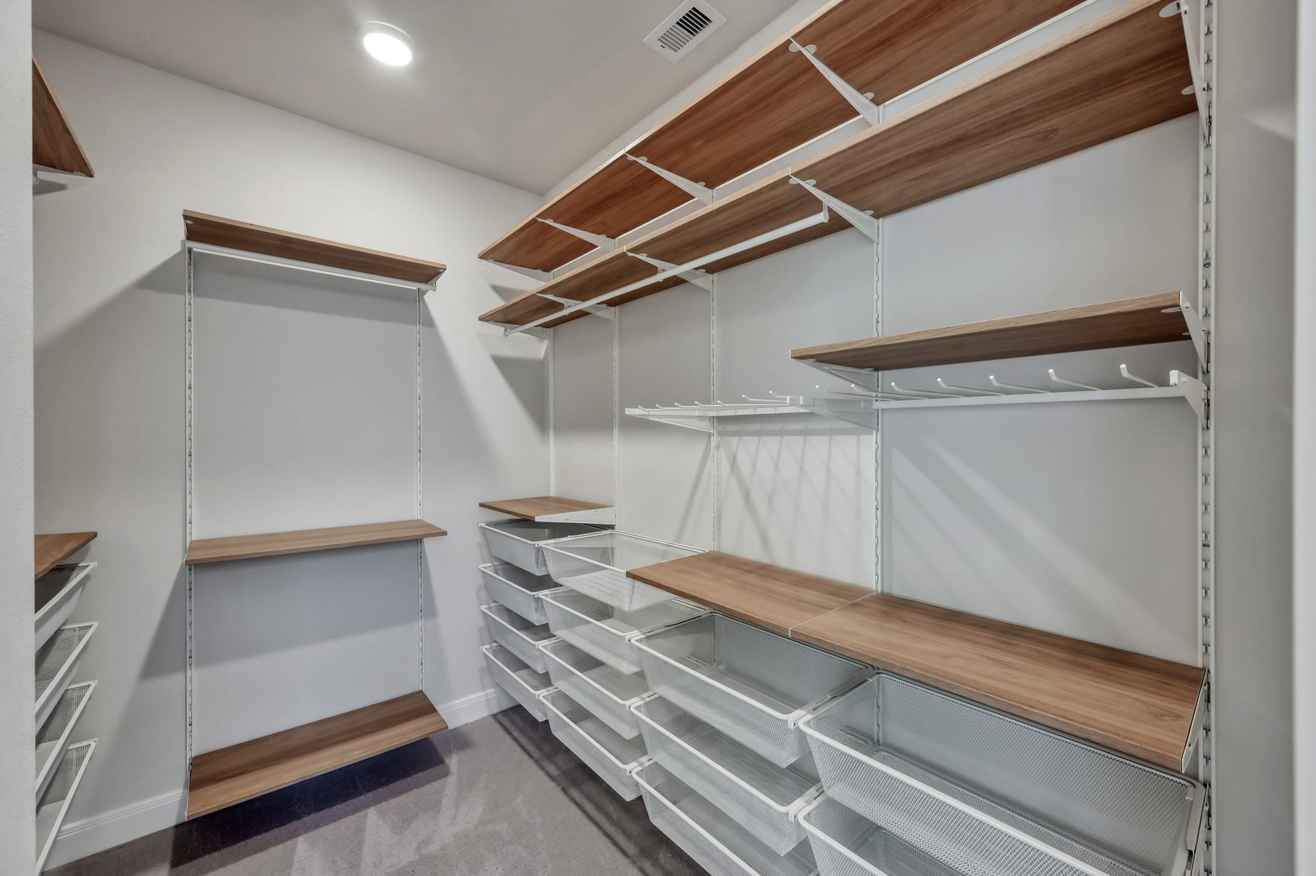 550 Chestnut Reef Court, Conroe, TX 77304 Spacious walk-in closet with custom shelving and built-in storage system.