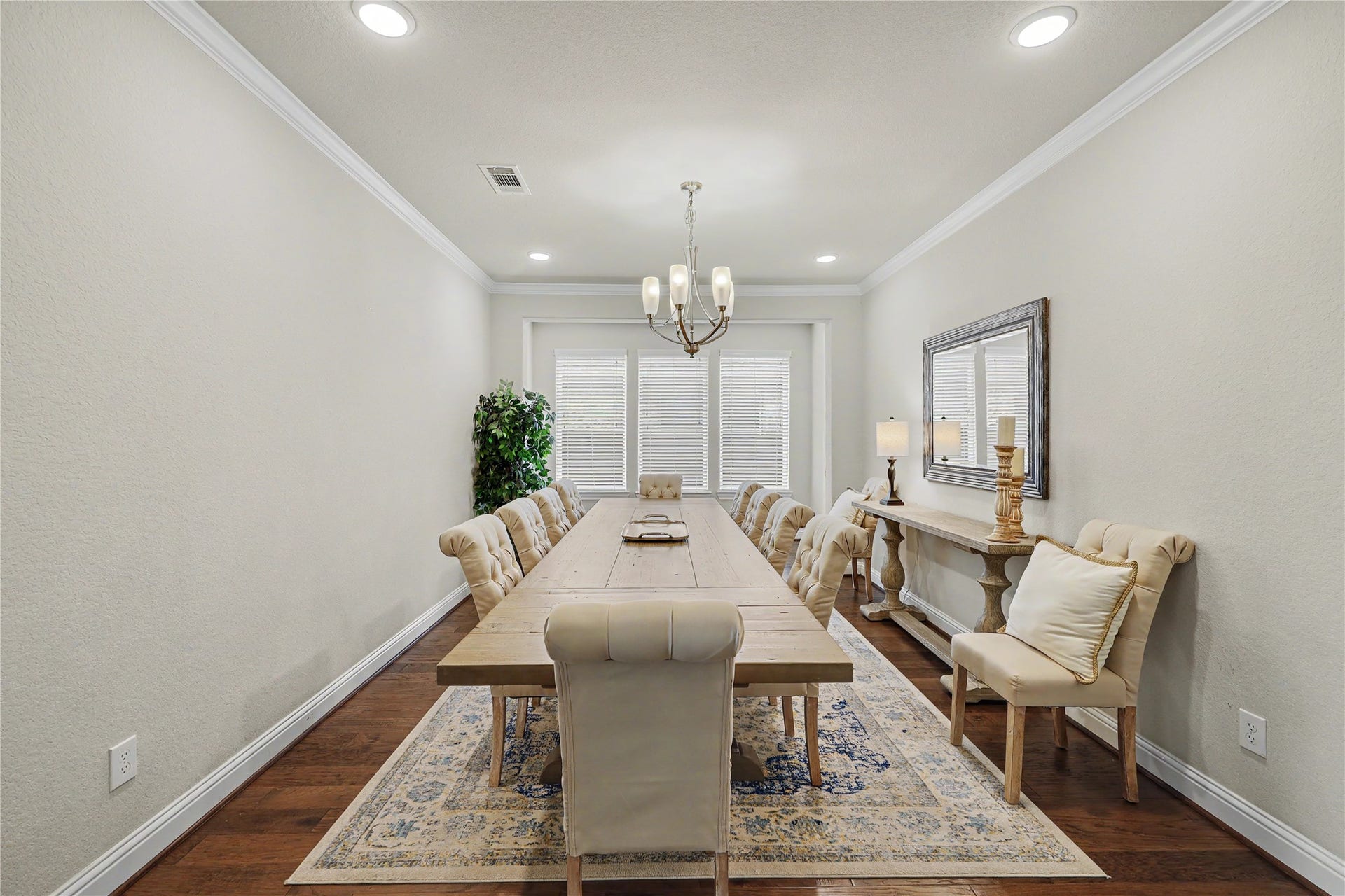 28216 Regal Wood Court, Spring, TX 77386 Formal dining room with tray ceiling, chandelier, and wood flooring.