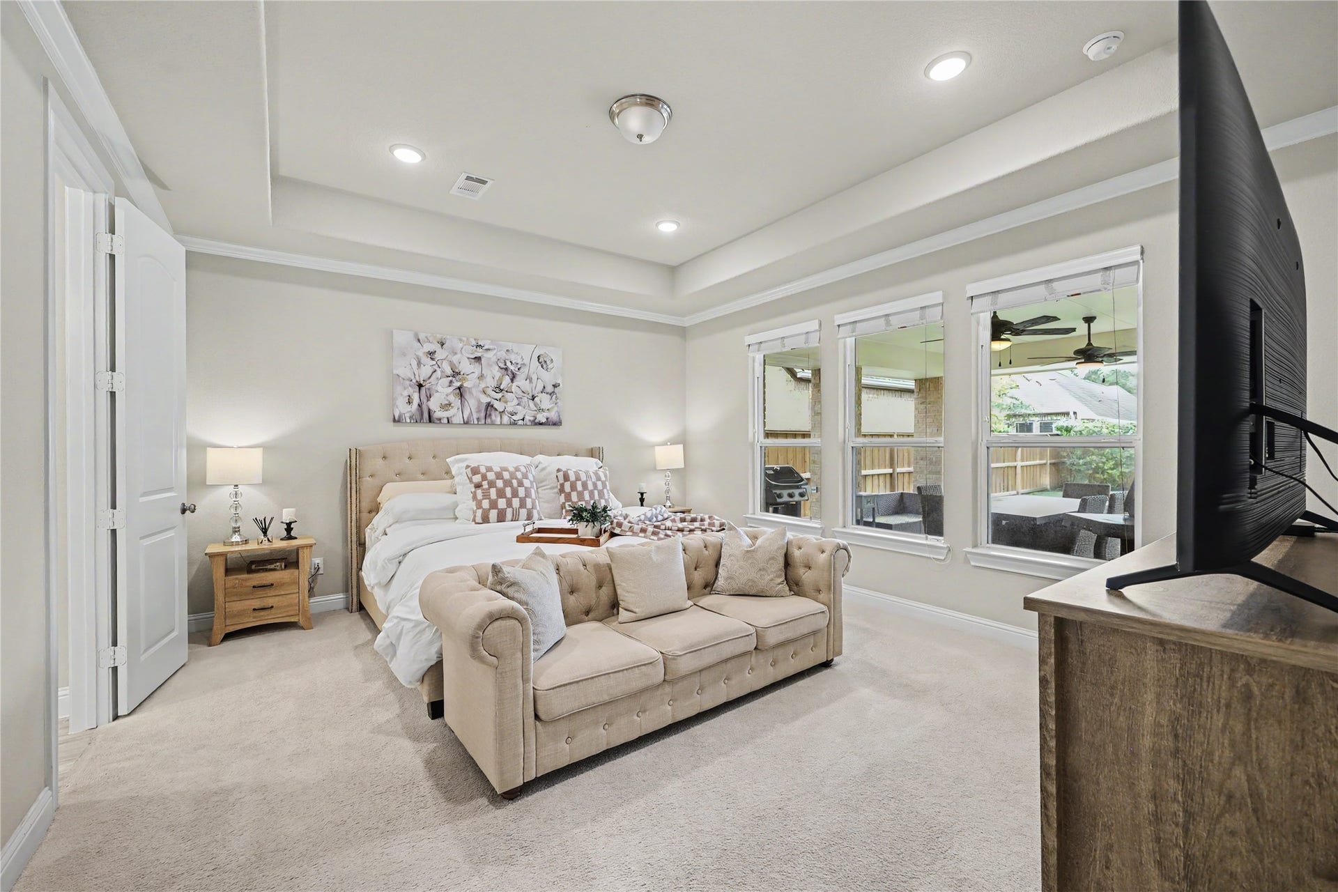 28216 Regal Wood Court, Spring, TX 77386 First-floor primary suite with tray ceiling, crown molding, and generous natural light.