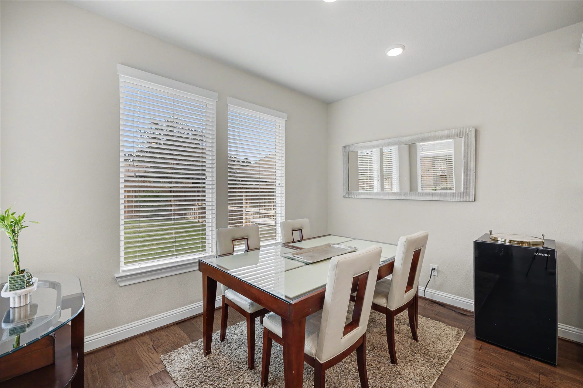28216 Regal Wood Court, Spring, TX 77386 Breakfast area with backyard-facing windows and wood flooring.