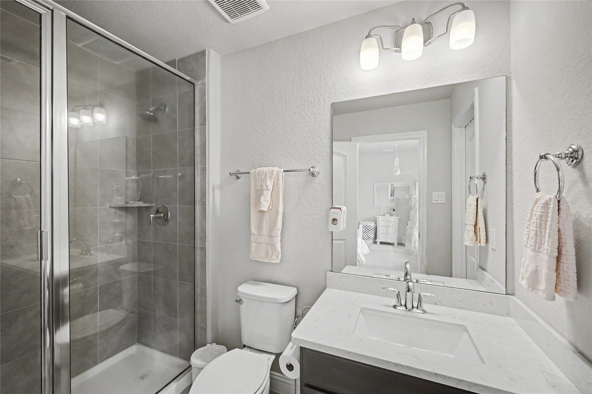 28216 Regal Wood Court, Spring, TX 77386 Secondary en-suite bathroom with vanity, framed mirror, and glass-enclosed shower.