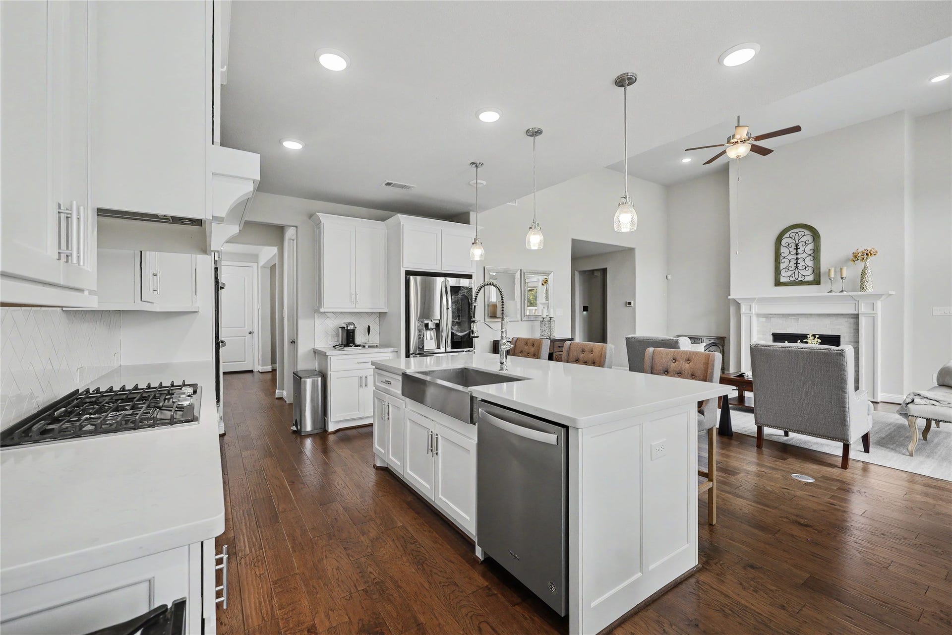 28216 Regal Wood Court, Spring, TX 77386 Open-concept kitchen and great room with wood flooring and abundant natural light.