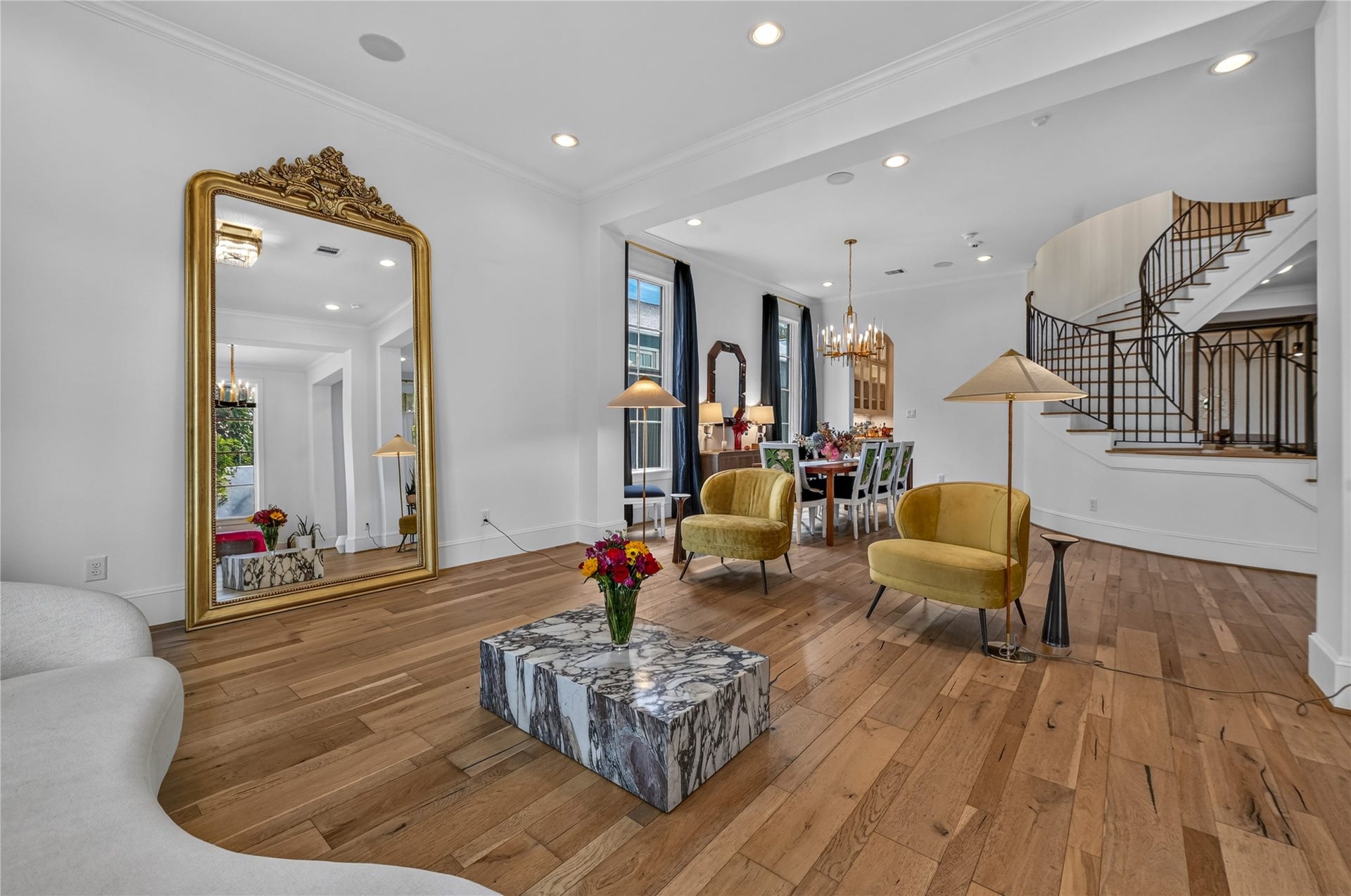 Formal living room opens up to the dining room & a stunning image of the spiral staircase.