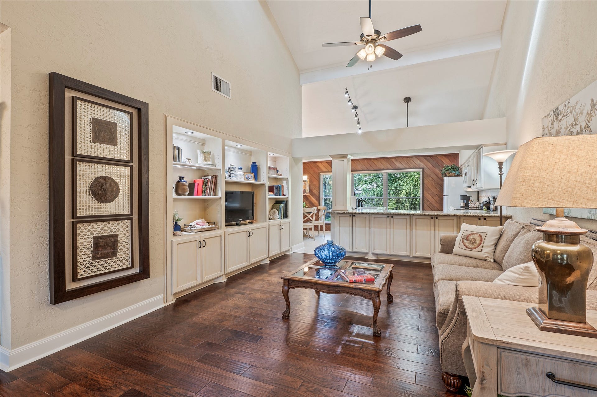 16530 Space Center Boulevard, Houston, TX 77058 Spacious living room with high ceilings and wood like flooring.