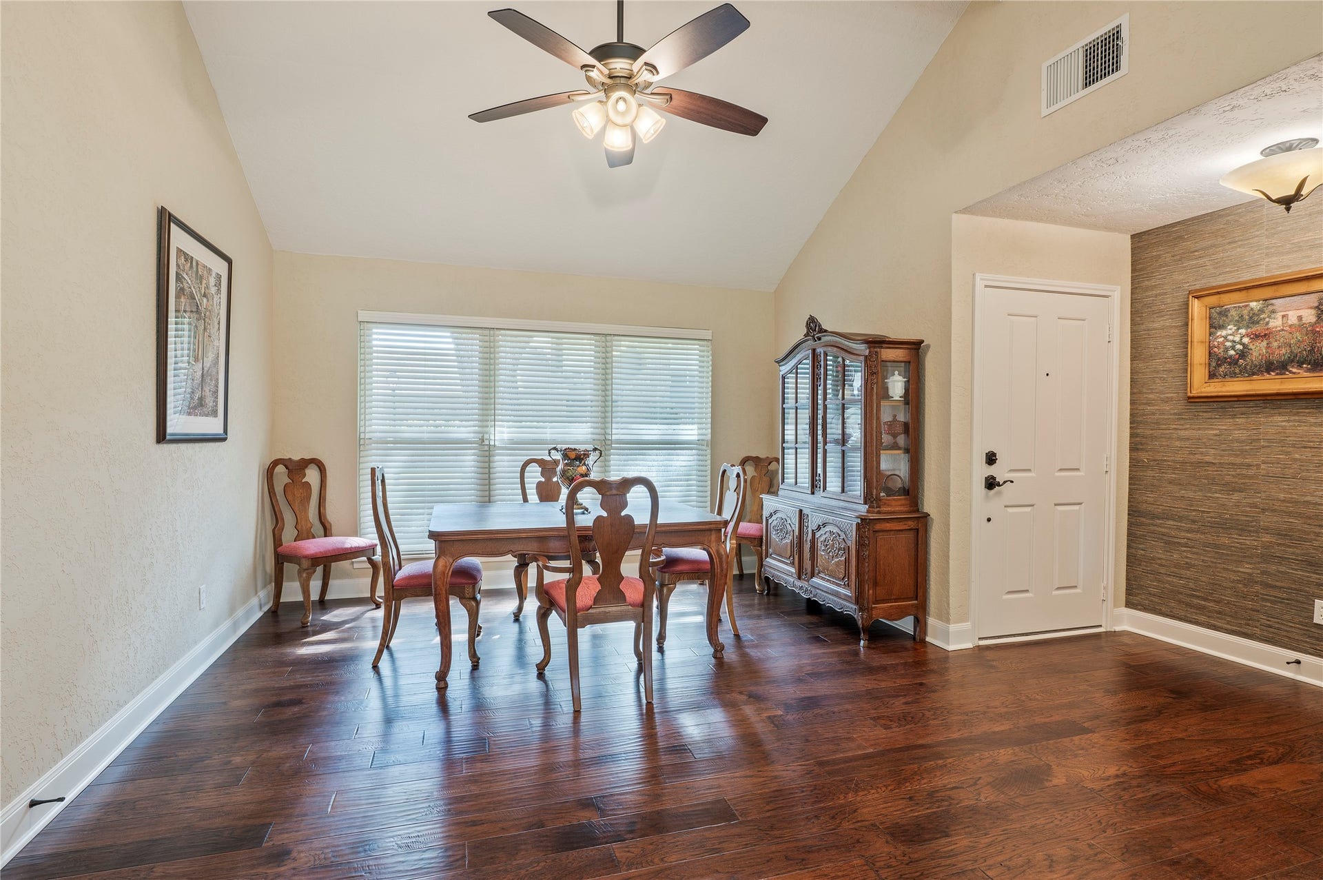 16530 Space Center Boulevard, Houston, TX 77058 Large formal dining area with wood like flooring, high ceilings, and ceiling fan fixture. Great natural lighting.
