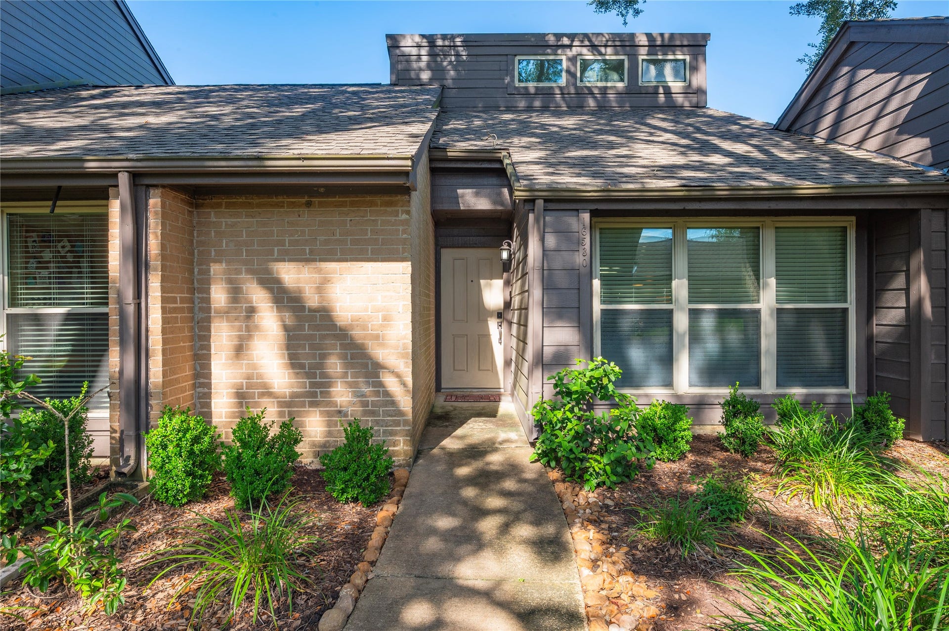 16530 Space Center Boulevard, Houston, TX 77058 Walkway leading up to the front entryway with beautiful landscaping.
