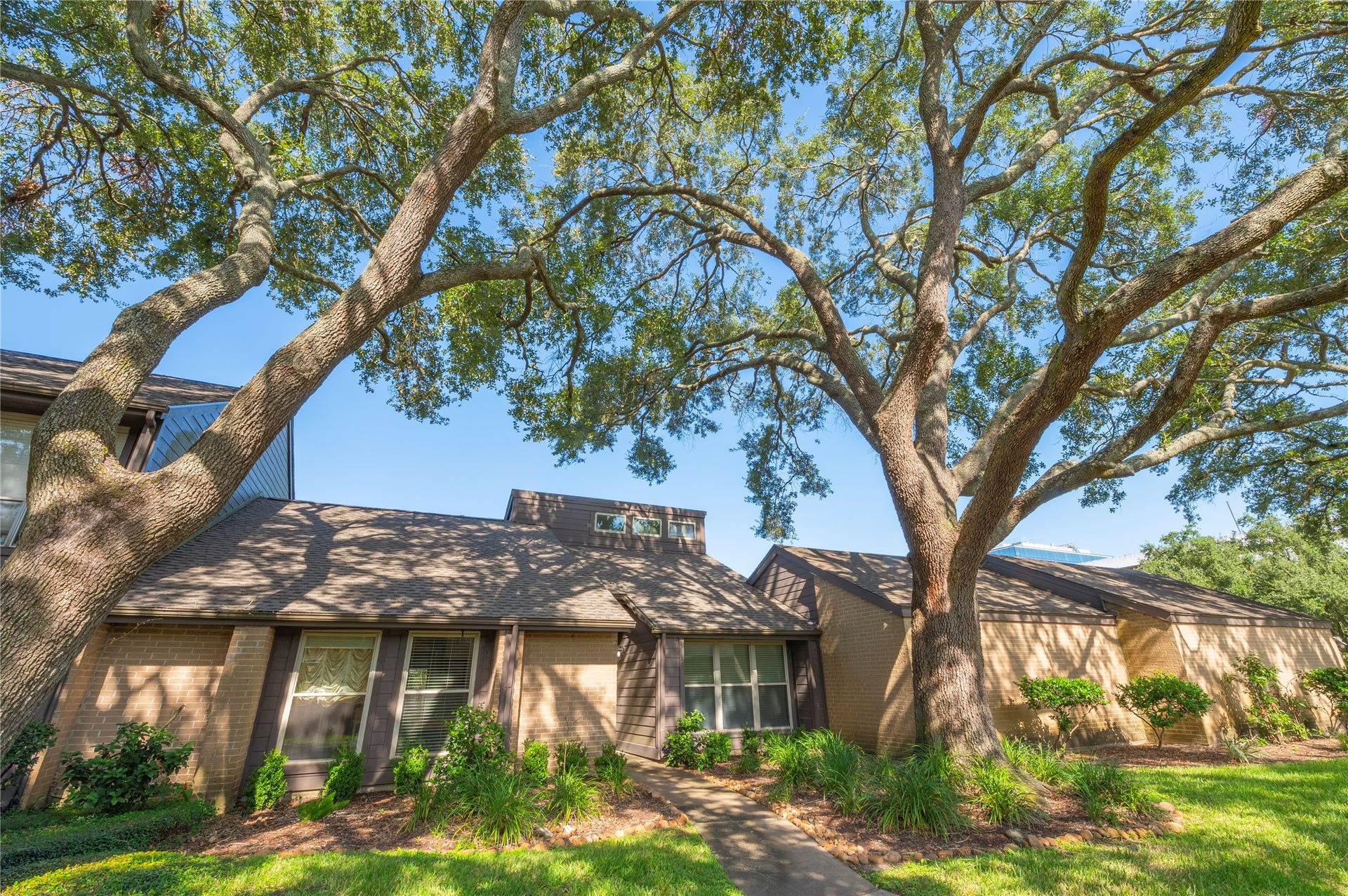 16530 Space Center Boulevard, Houston, TX 77058 Tall oak trees throughout the community.