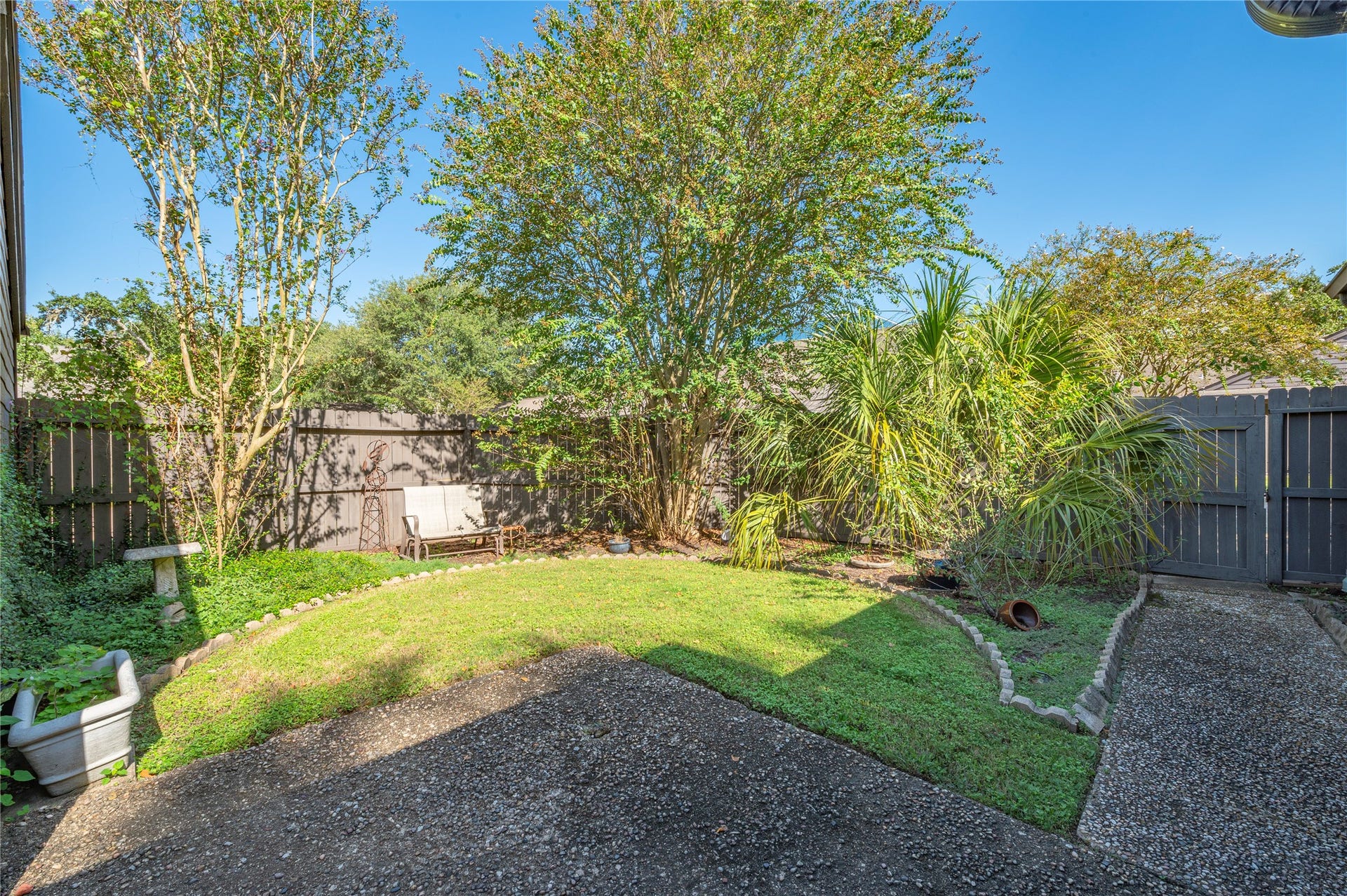 16530 Space Center Boulevard, Houston, TX 77058 Yard space and landscaping with privacy fencing on all sides in the backyard.