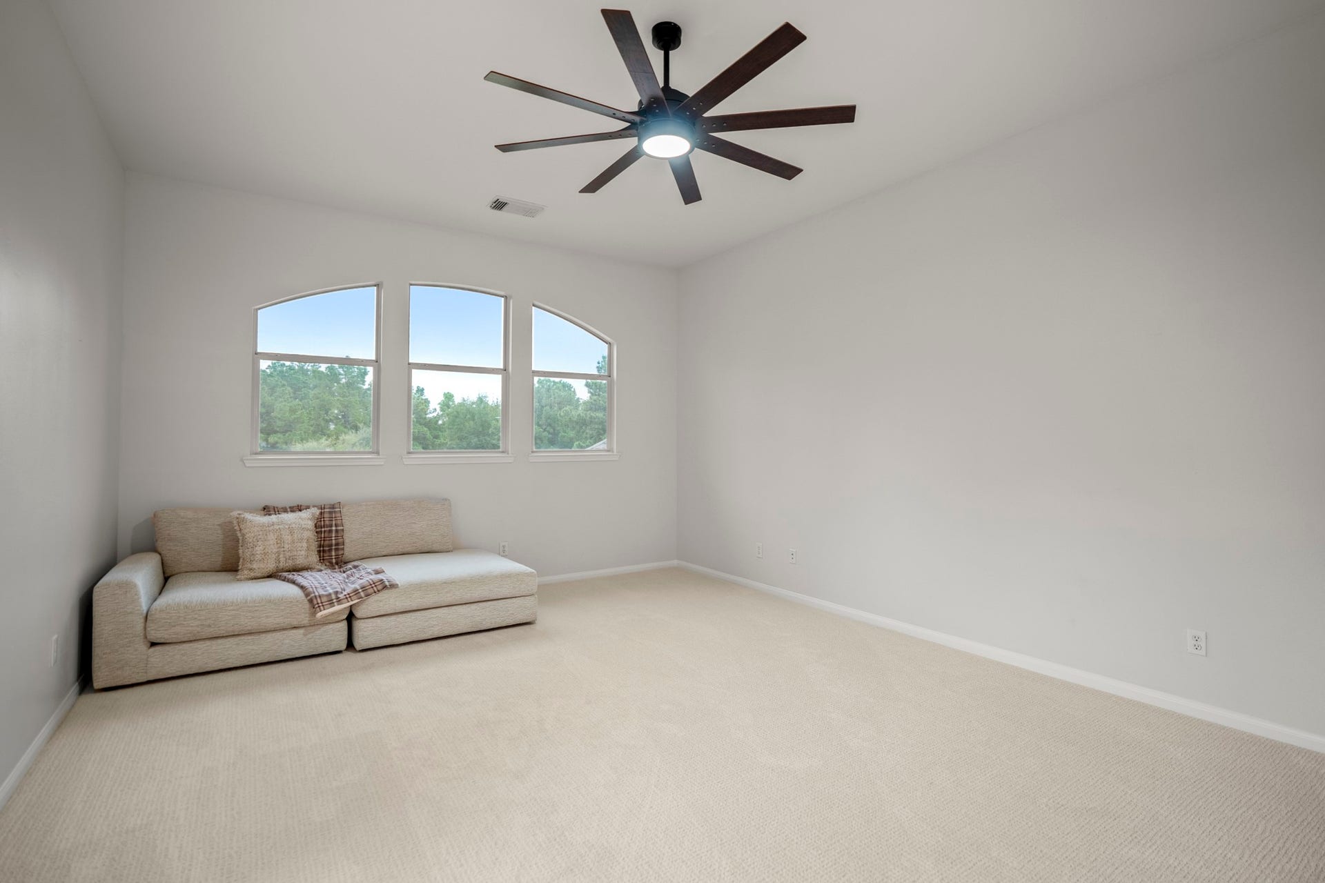 Upstairs you have this huge game room, which has plenty of space for multiple gaming area as well as a nice size trio of windows and large modern ceiling fans.
