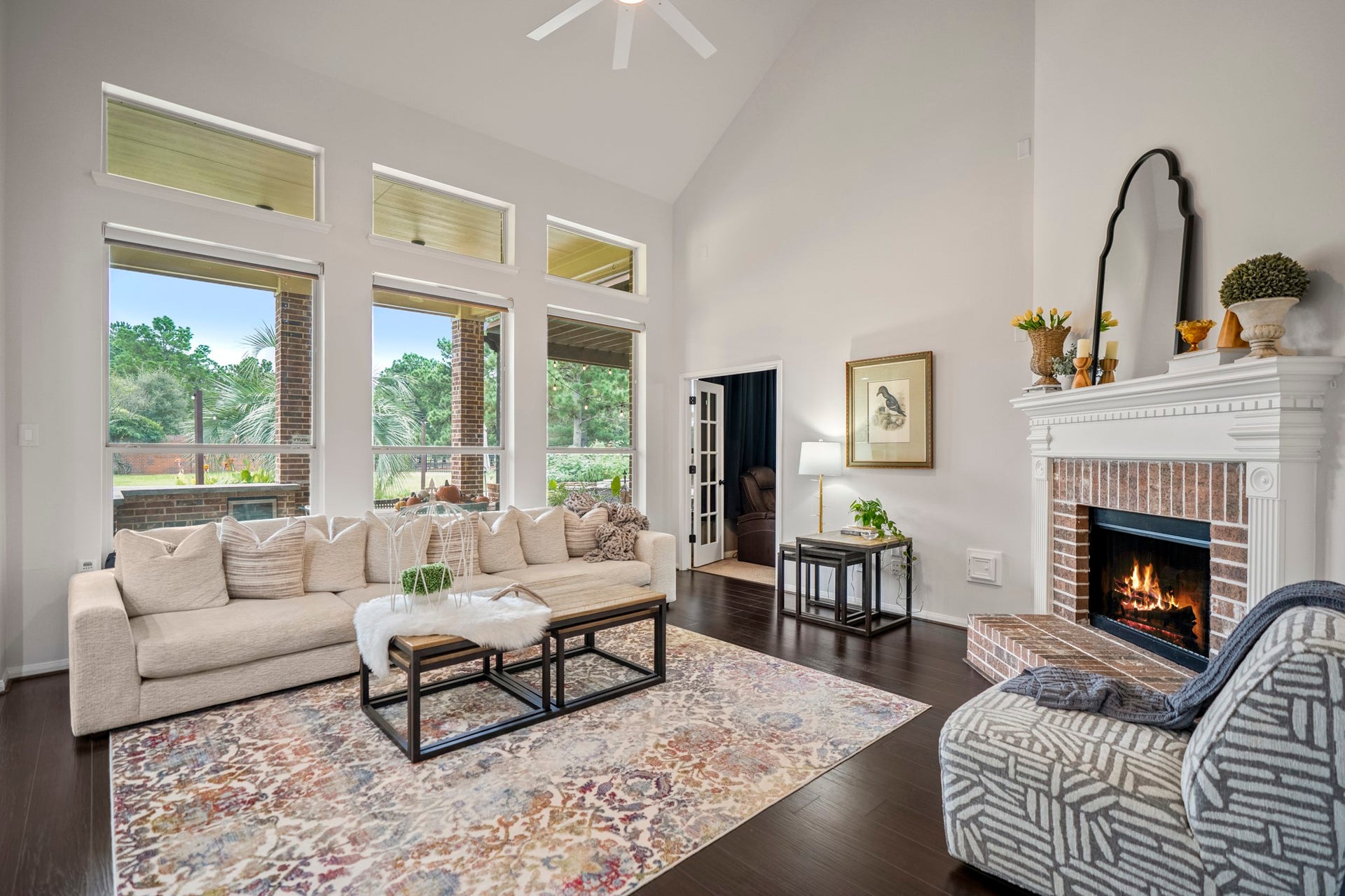 Boasting soaring cathedral ceilings and a dramatic wall of windows, this space offers beautiful views of the backyard and golf course, while flooding the home with brilliant natural light.