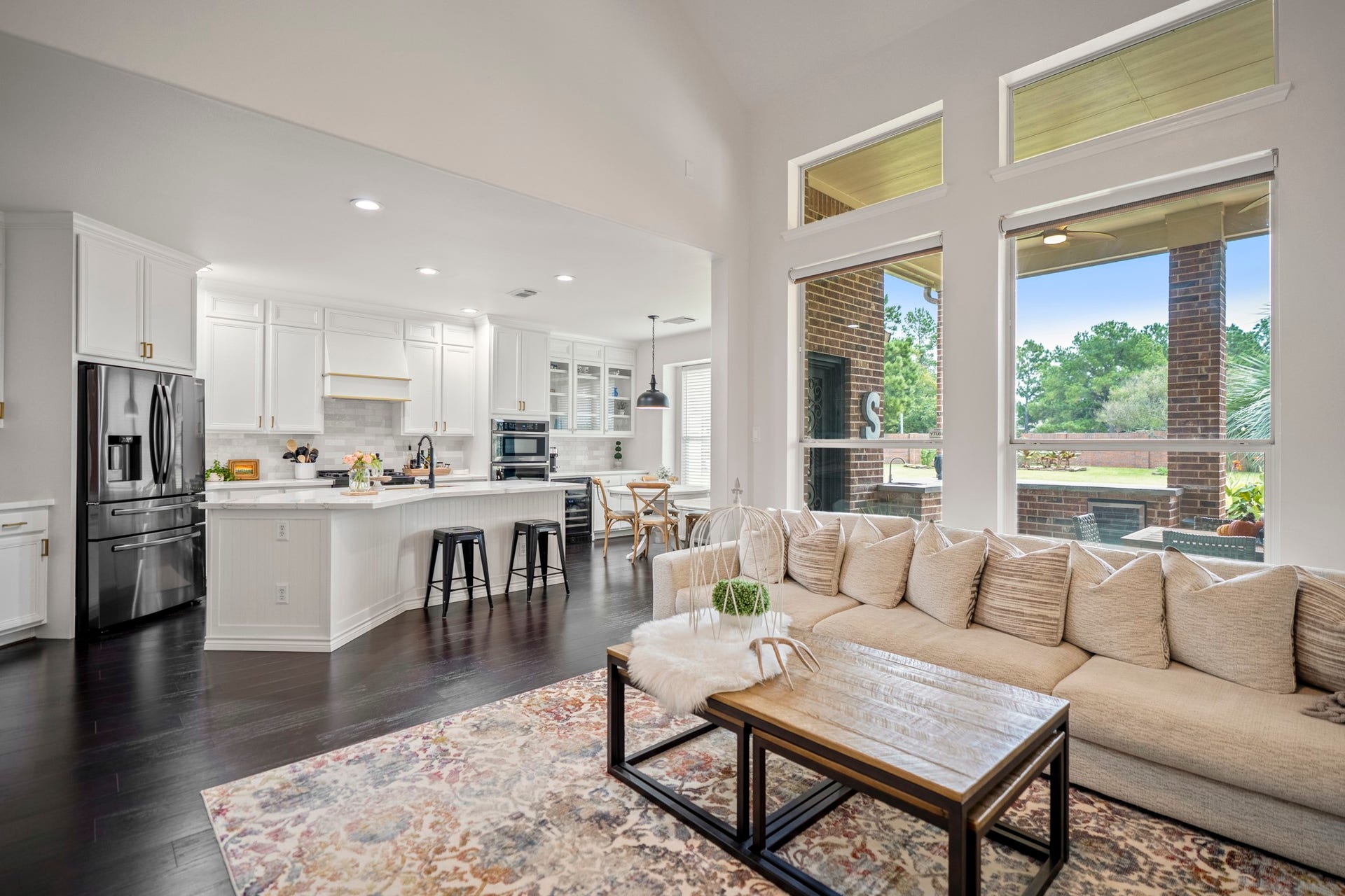 The rich, dark wood like flooring contrasts beautifully against the crisp, neutral walls, creating an upscale environment that serves as the ultimate backdrop for both high-end entertaining and comfortable day-to-day living.